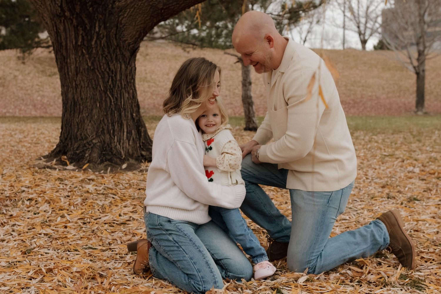 Family spending a quiet autumn moment together outdoors, capturing natural connection and genuine family photography