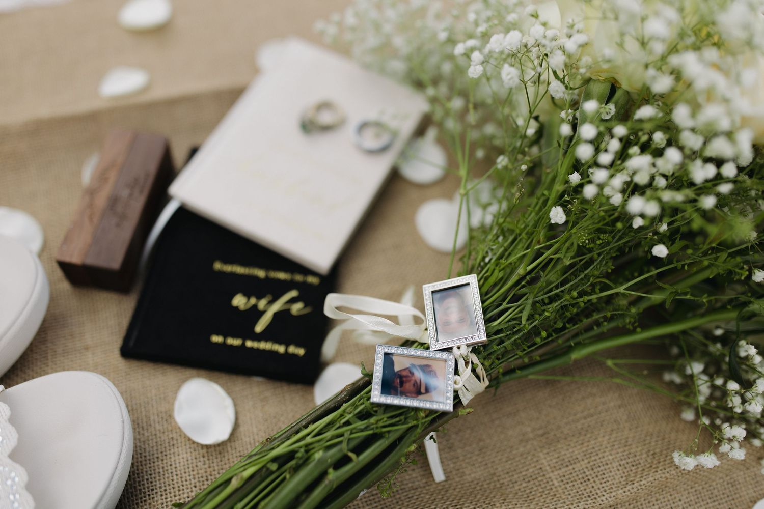 Wedding details with rings, invitations, flowers, and keepsakes
