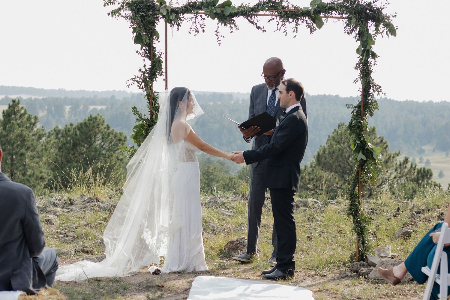 Bride and groom exchanging vows during an outdoor wedding ceremony