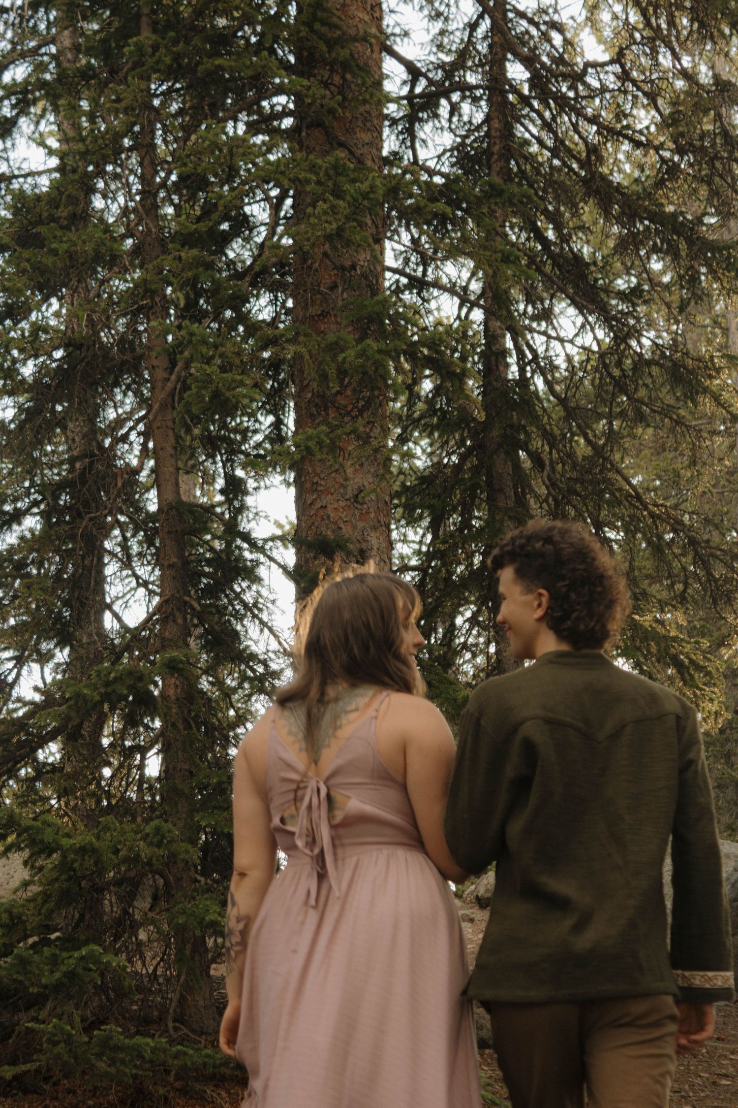 Couple walking together through a peaceful forest during a natural and intimate couples photography session