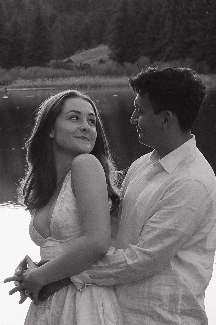Couple sharing an intimate moment outdoors during a romantic black and white couples photography session