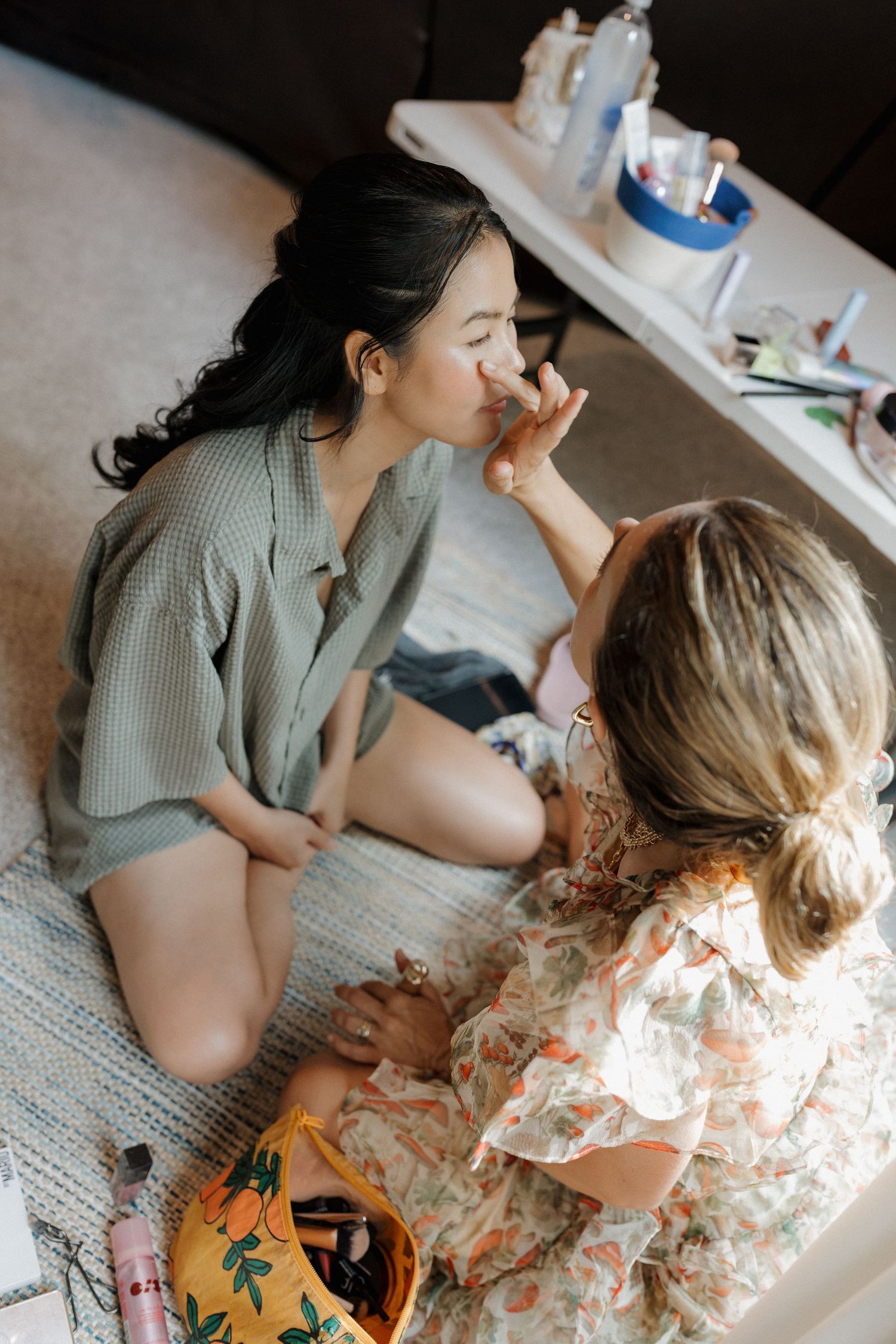 Bride getting ready with her bridesmaid during a wedding morning