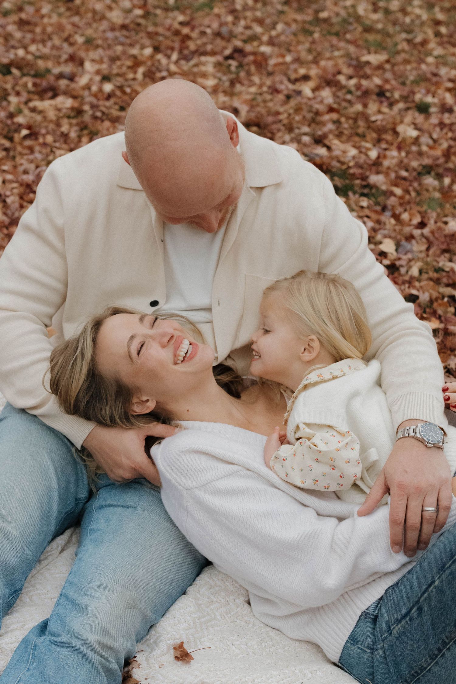 Father and child sharing a playful and affectionate moment outdoors during a warm family photography session