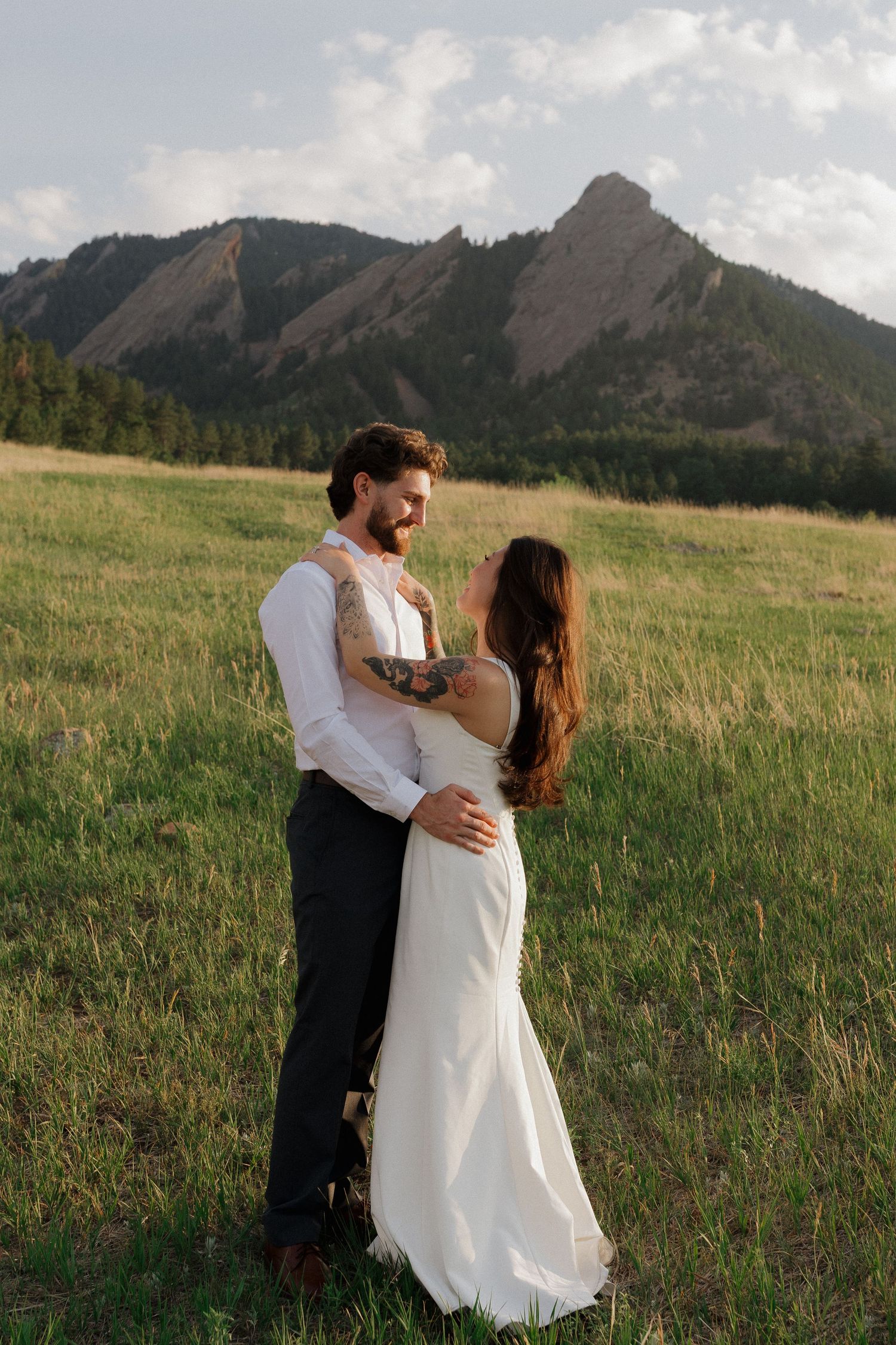 Couple embracing in a Colorado mountain meadow during a romantic outdoor couples photography session