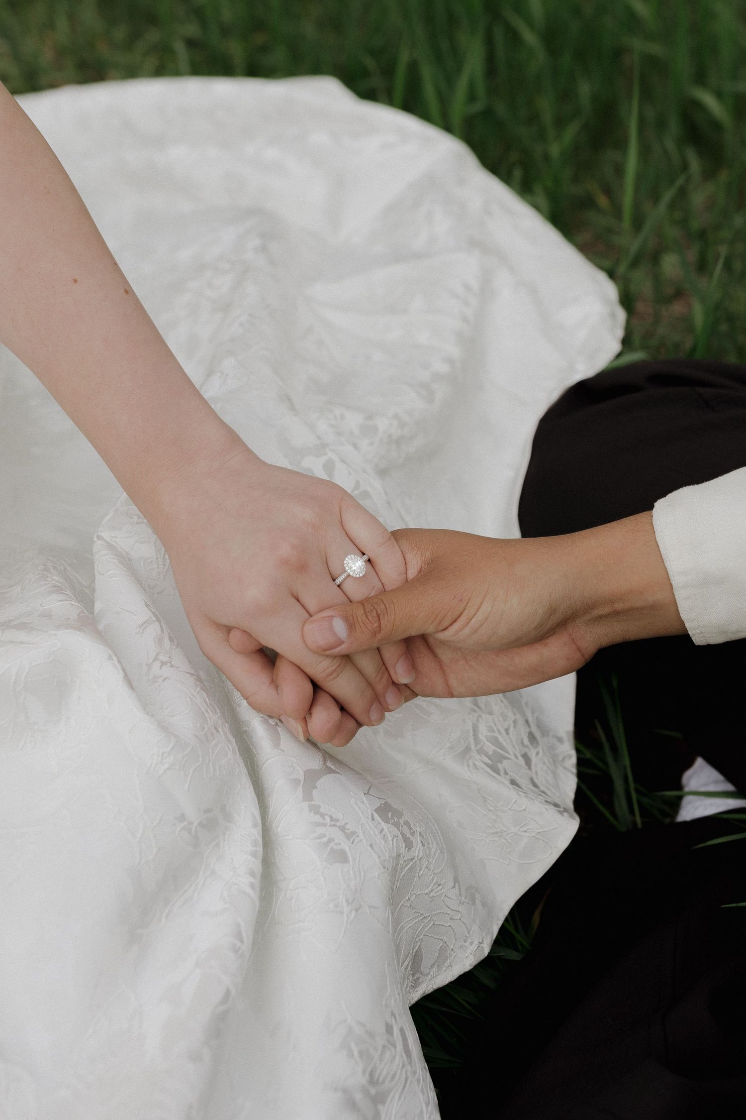 Close-up of a couple holding hands, engagement