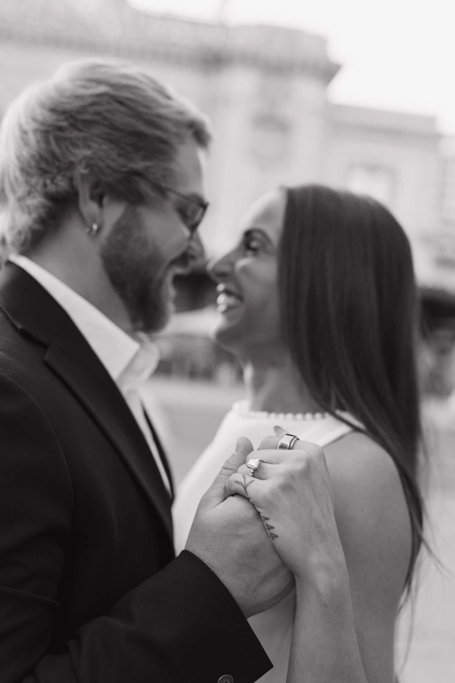 Black and white portrait of a couple smiling and looking at each other