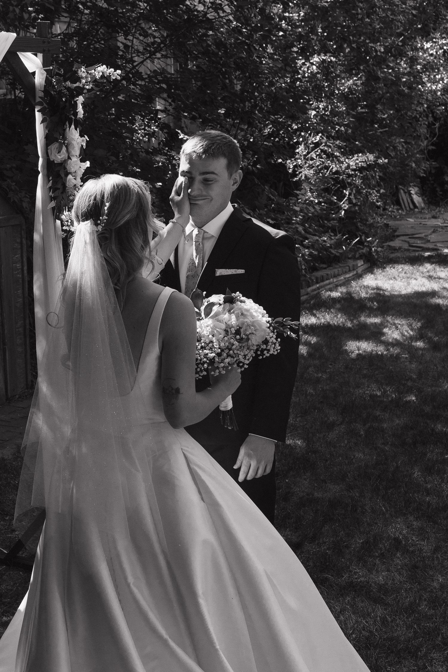 Bride and groom sharing a tender moment together during their wedding day