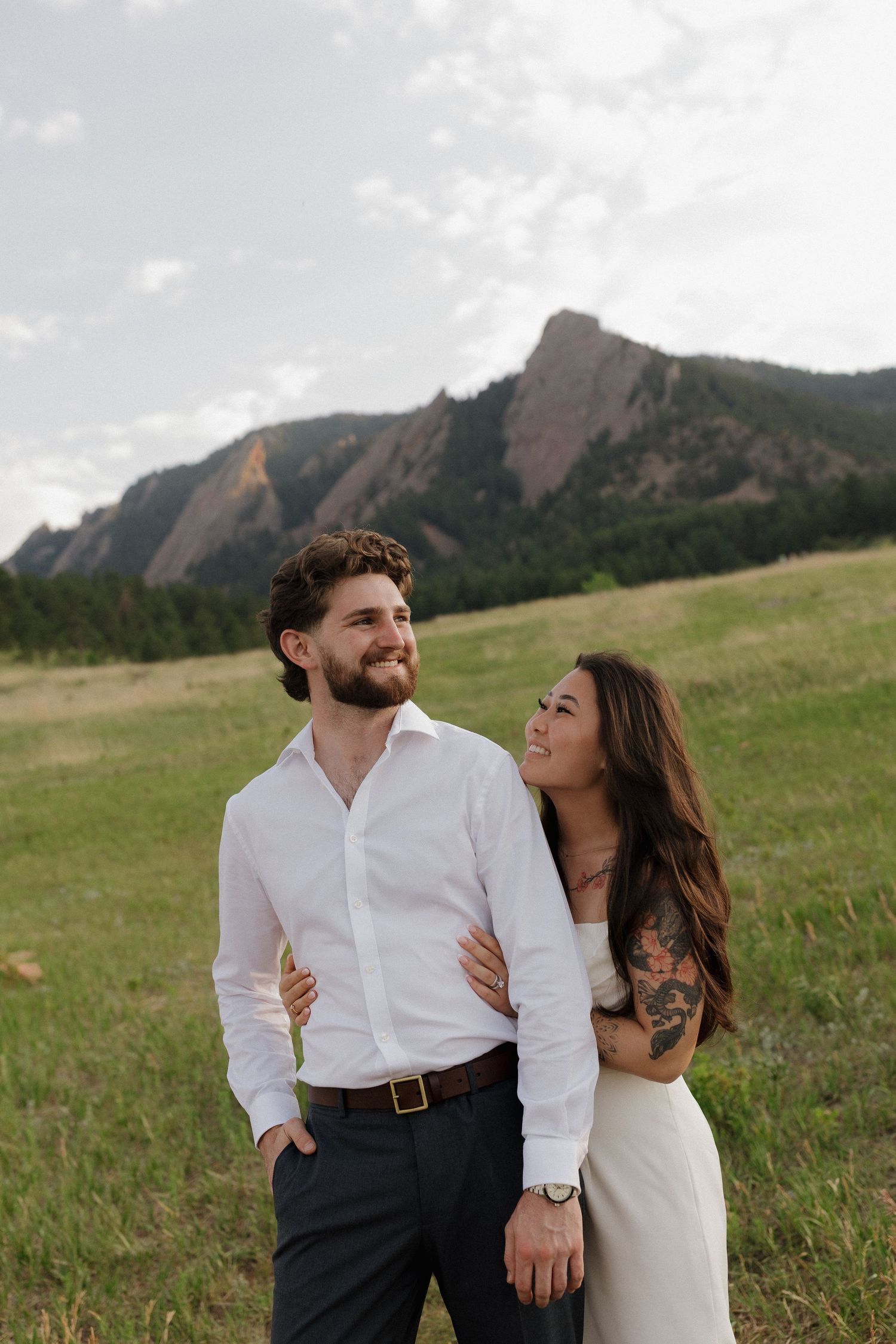 Couple standing together in a Colorado mountain meadow during a warm and natural couples photography session