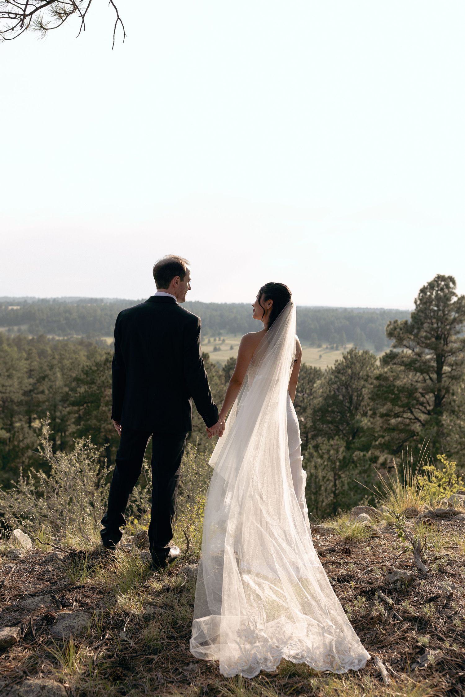 Bride and groom sharing a glance of eyes during their outdoor wedding celebration