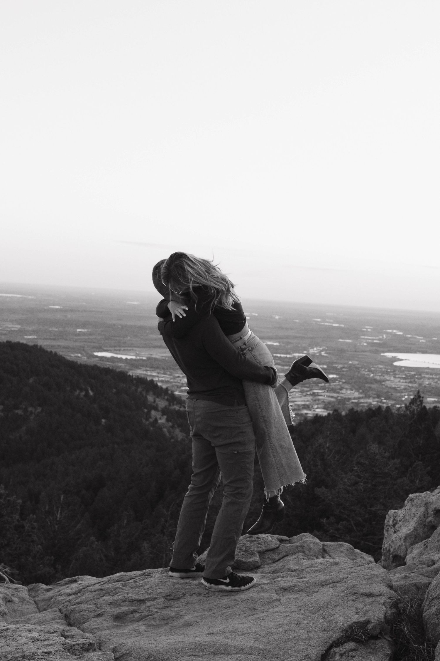 Couple embracing on a mountain overlook during an intimate black and white couples photography session