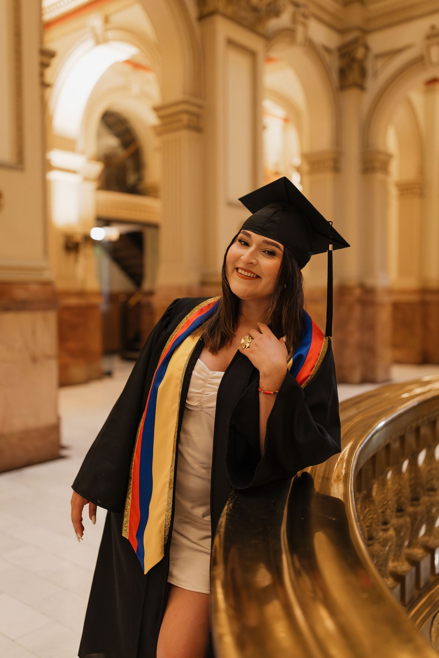 Graduate walking through a beautiful historic church in a cap and gown