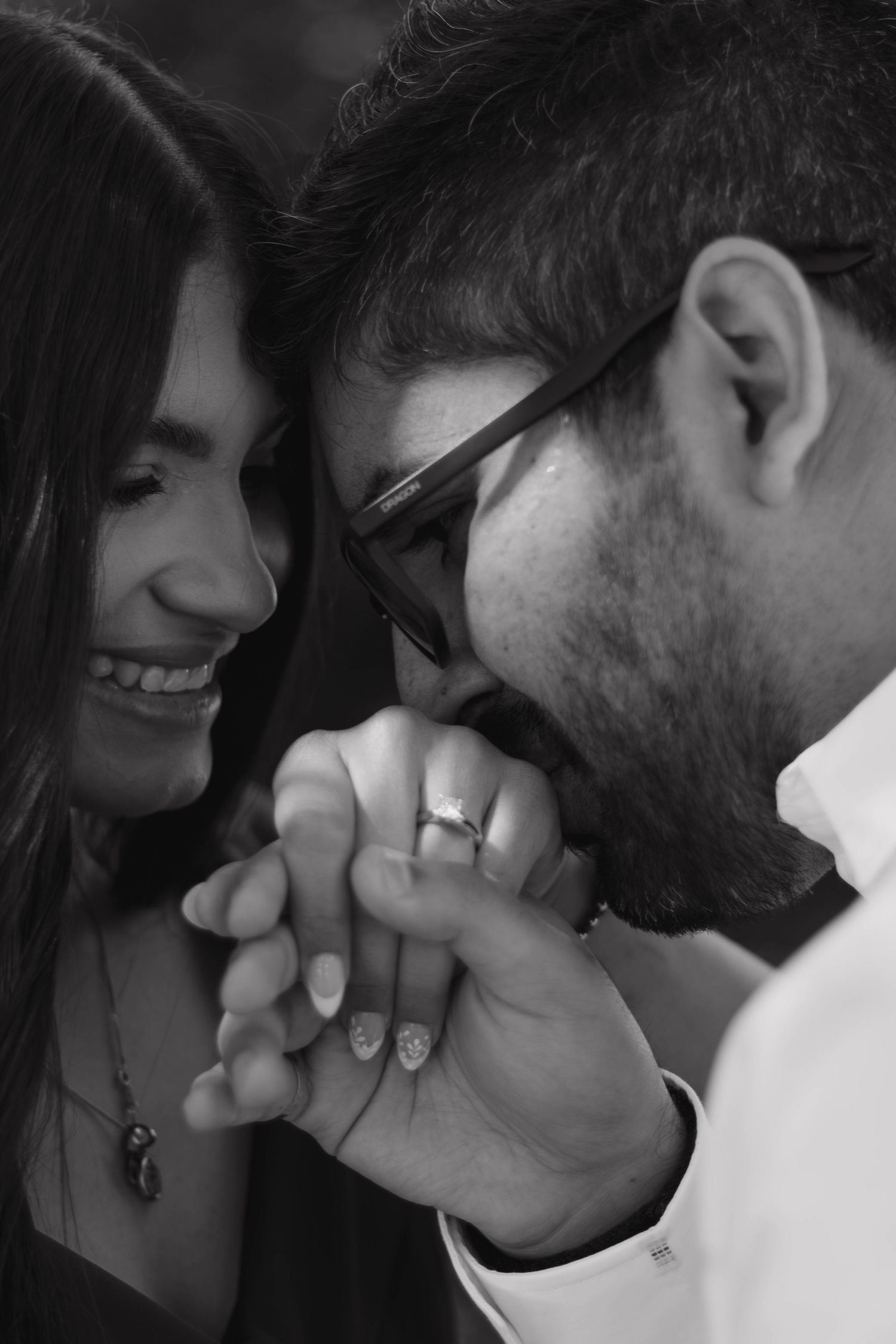 Bride and groom sharing an intimate moment and holding hands on their engagement day