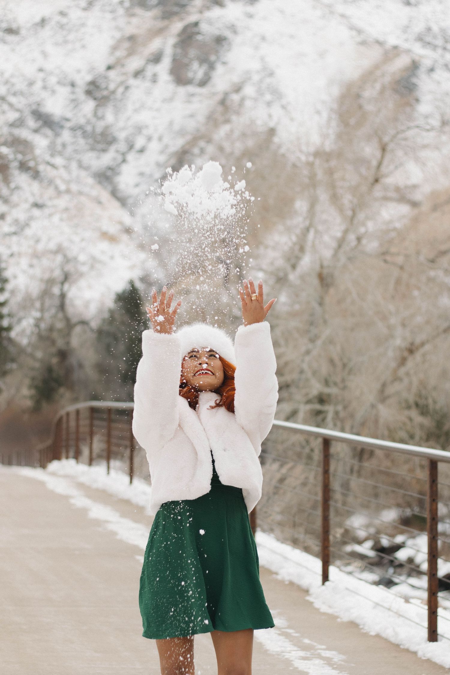 Woman smiling outdoors in a snowy setting during a natural winter portrait photography session