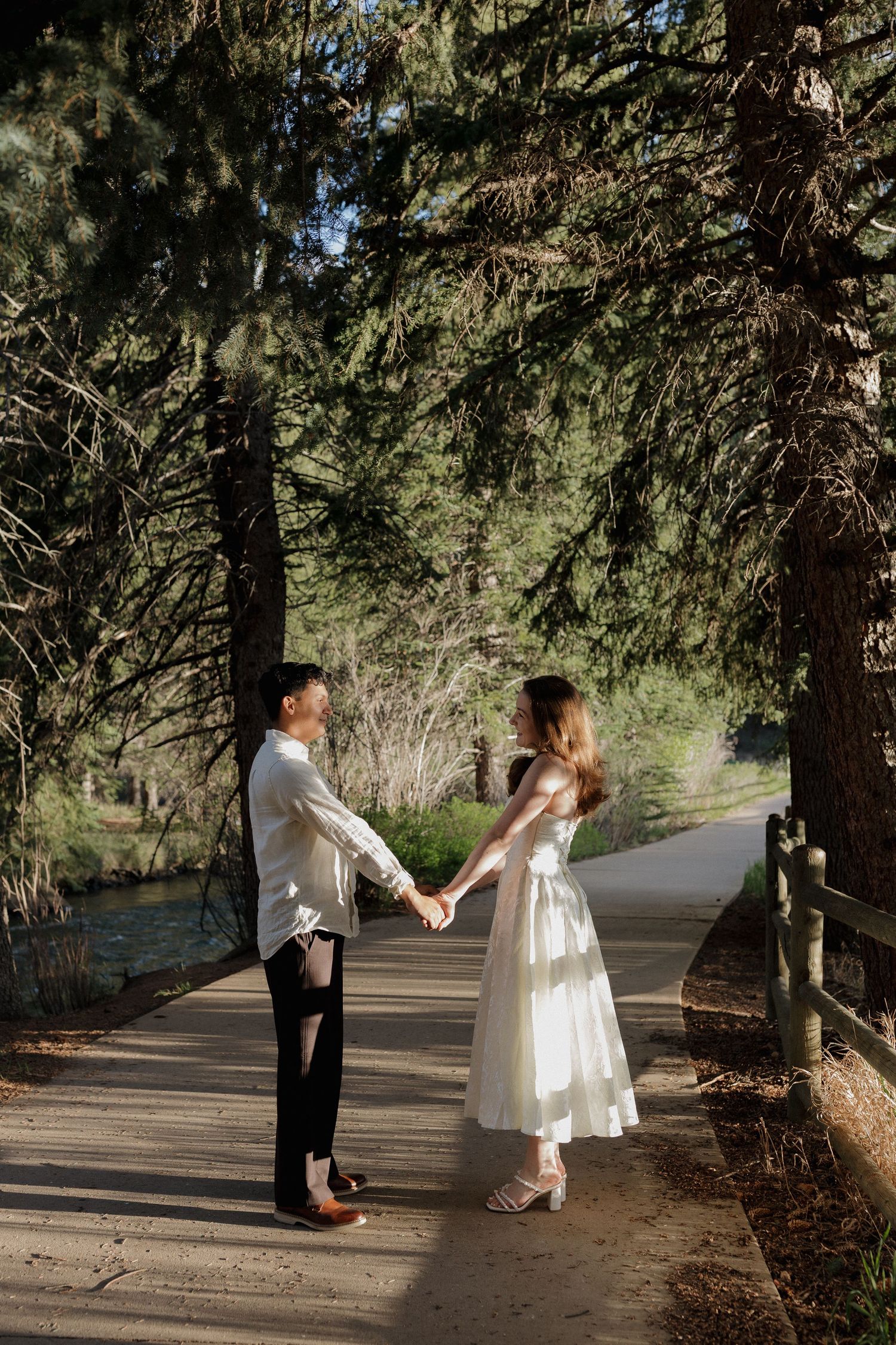 Couple walking together on a forest path during a natural outdoor couples photography session