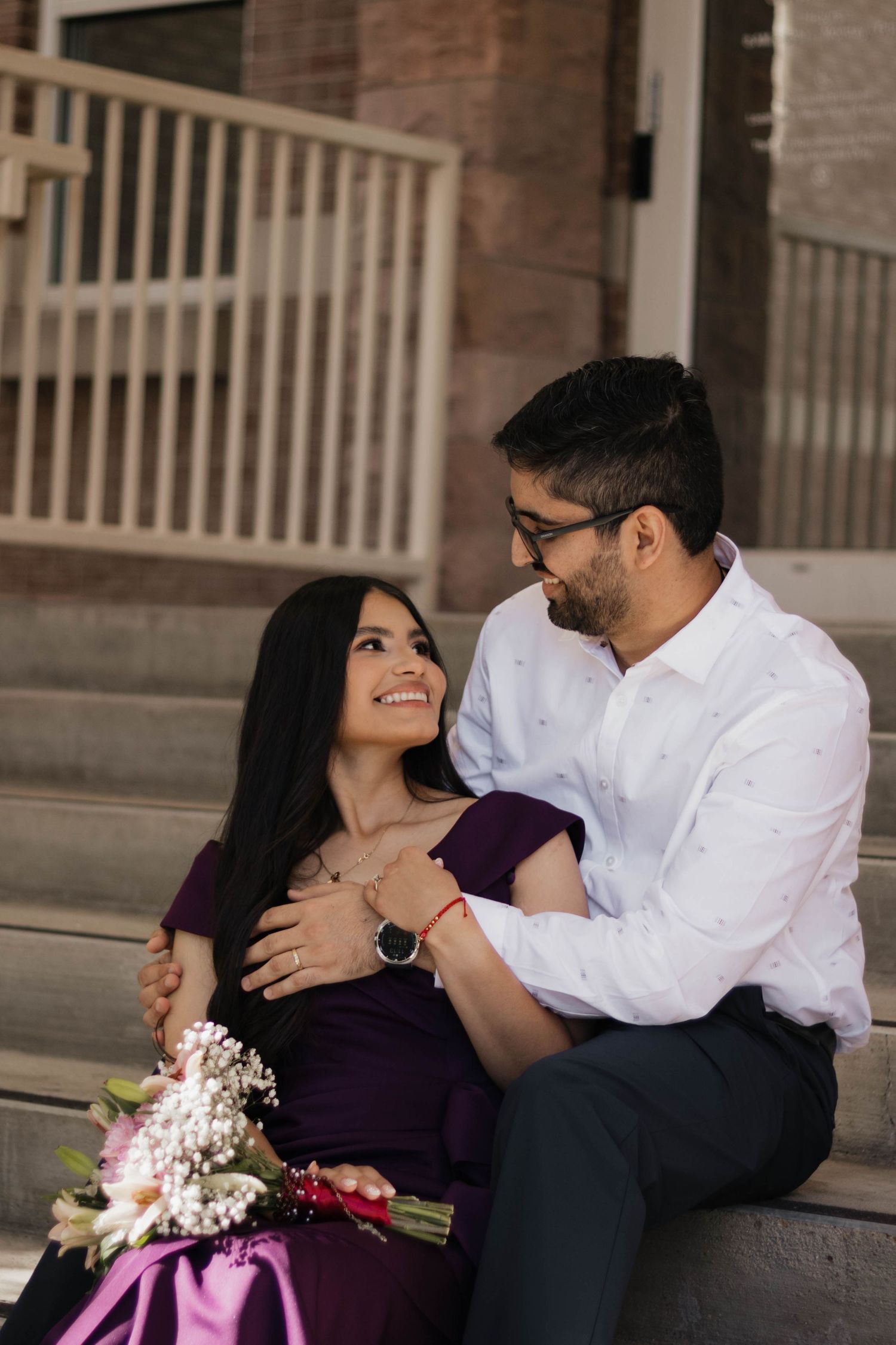 Engaged couple sitting together, sharing a quiet and intimate moment during their engagement session