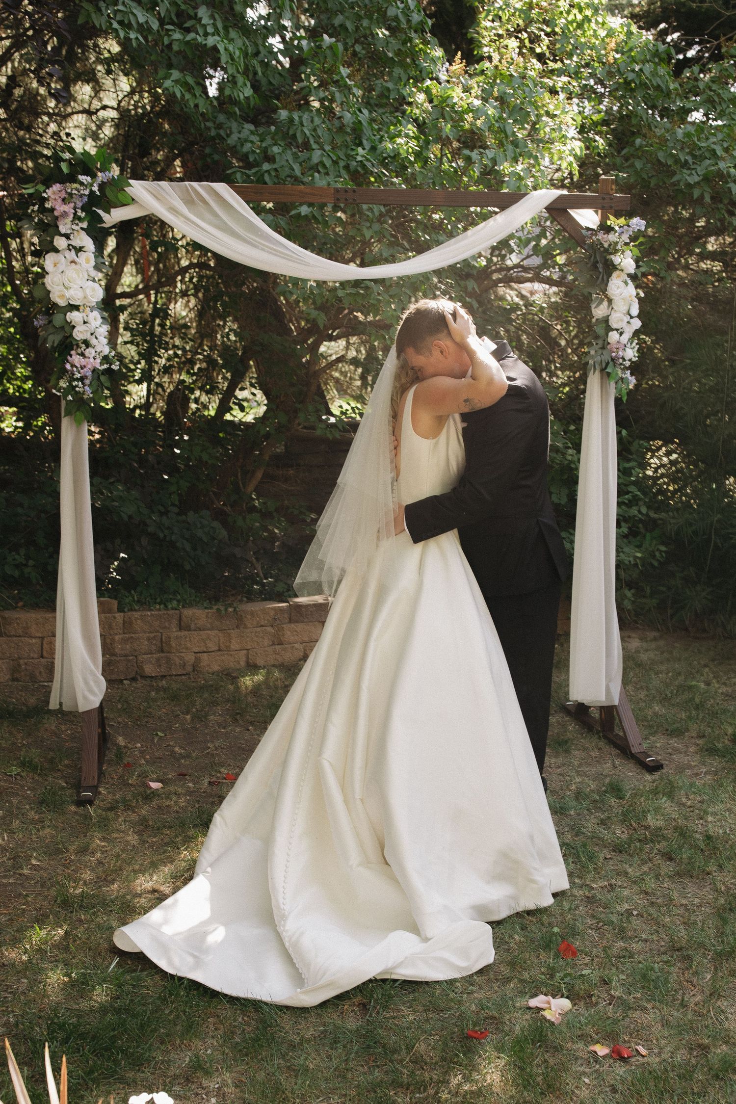 Newlywed couple embracing after their wedding ceremony
