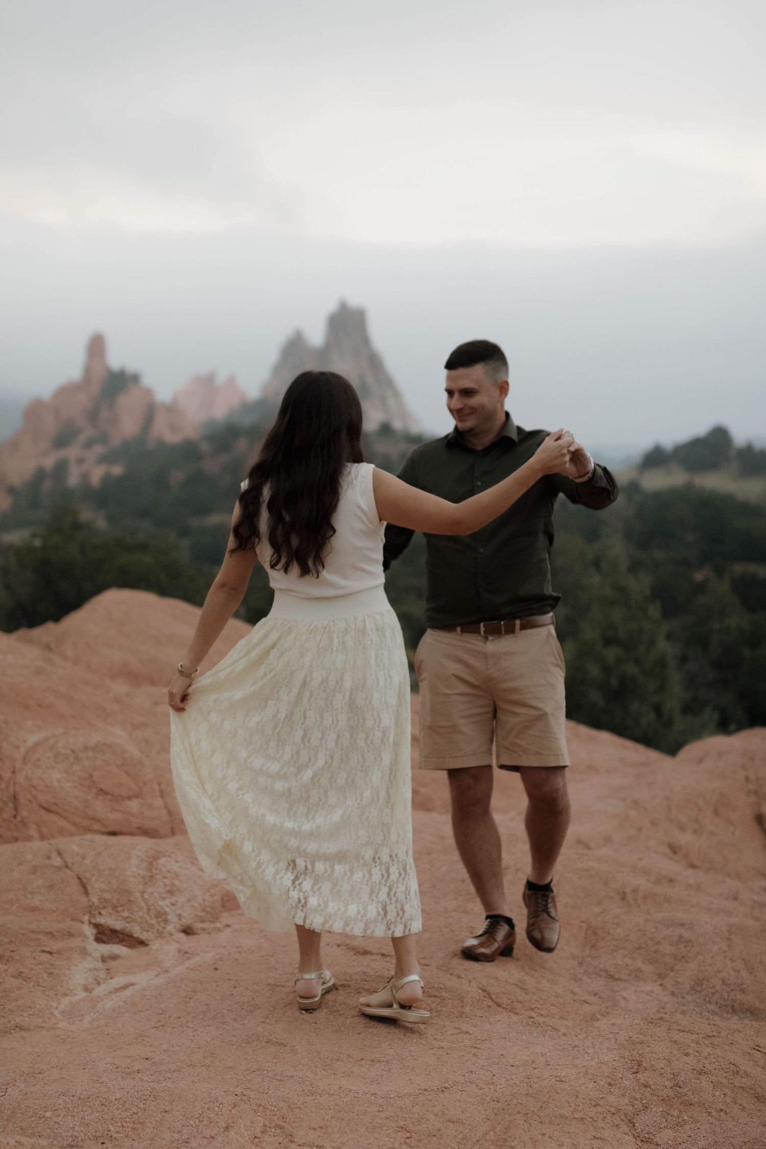 Couple walking together through a scenic mountain landscape during a natural and adventurous couples photography session