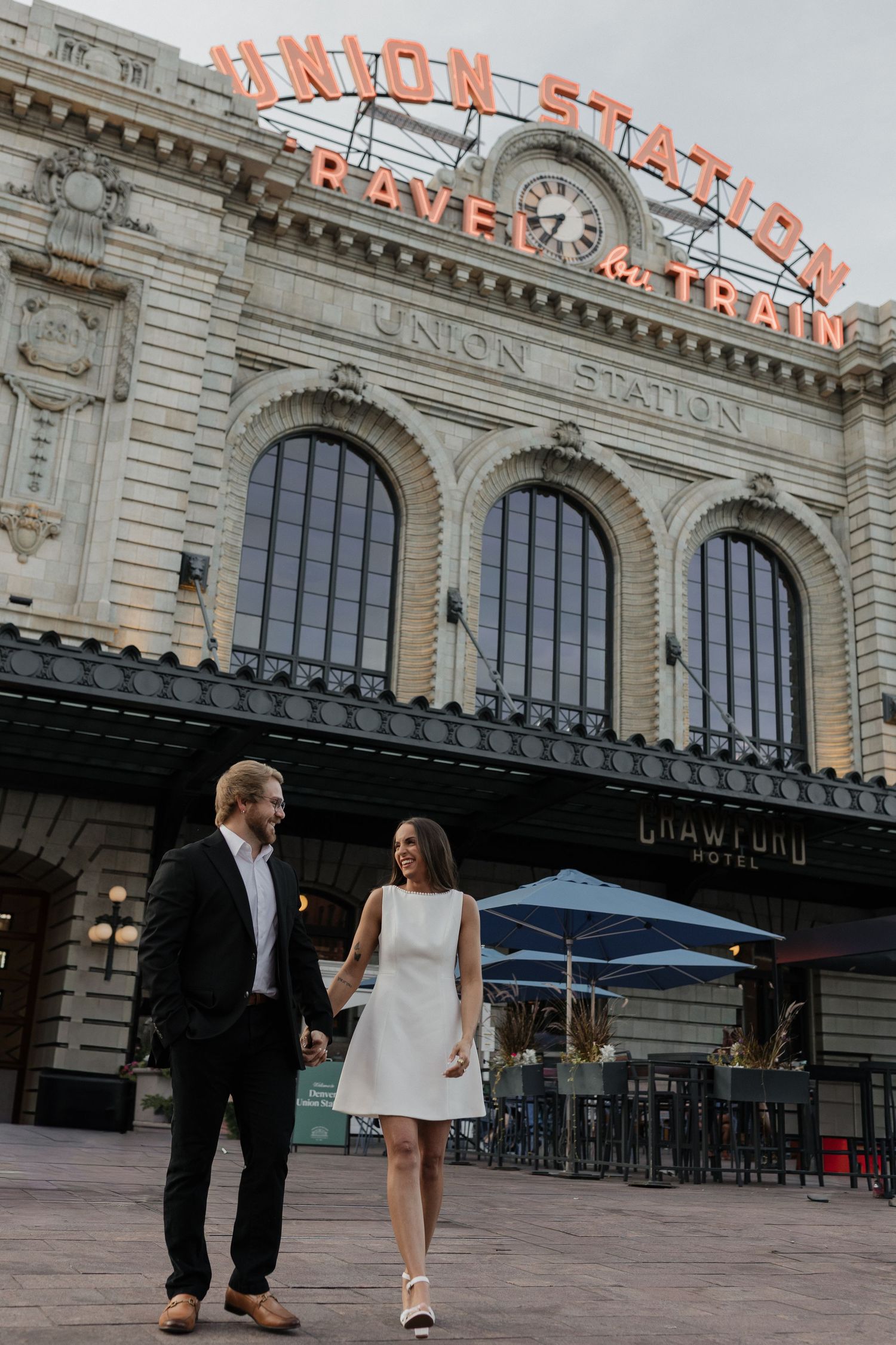 Couple walking together outside Union Station during an urban couples session