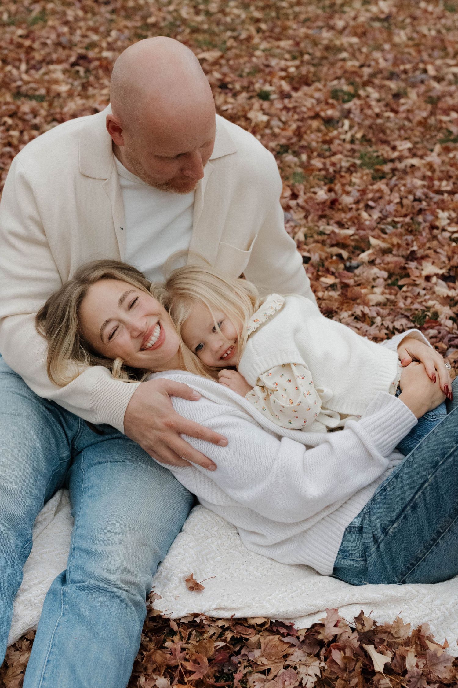 Father and child sharing a quiet moment together outdoors during a warm and natural family photography session