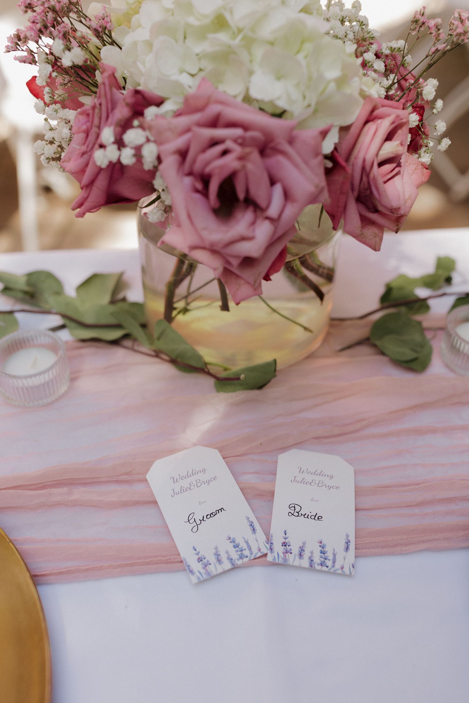 Close-up of wedding reception details with flowers, place cards, and elegant table decor