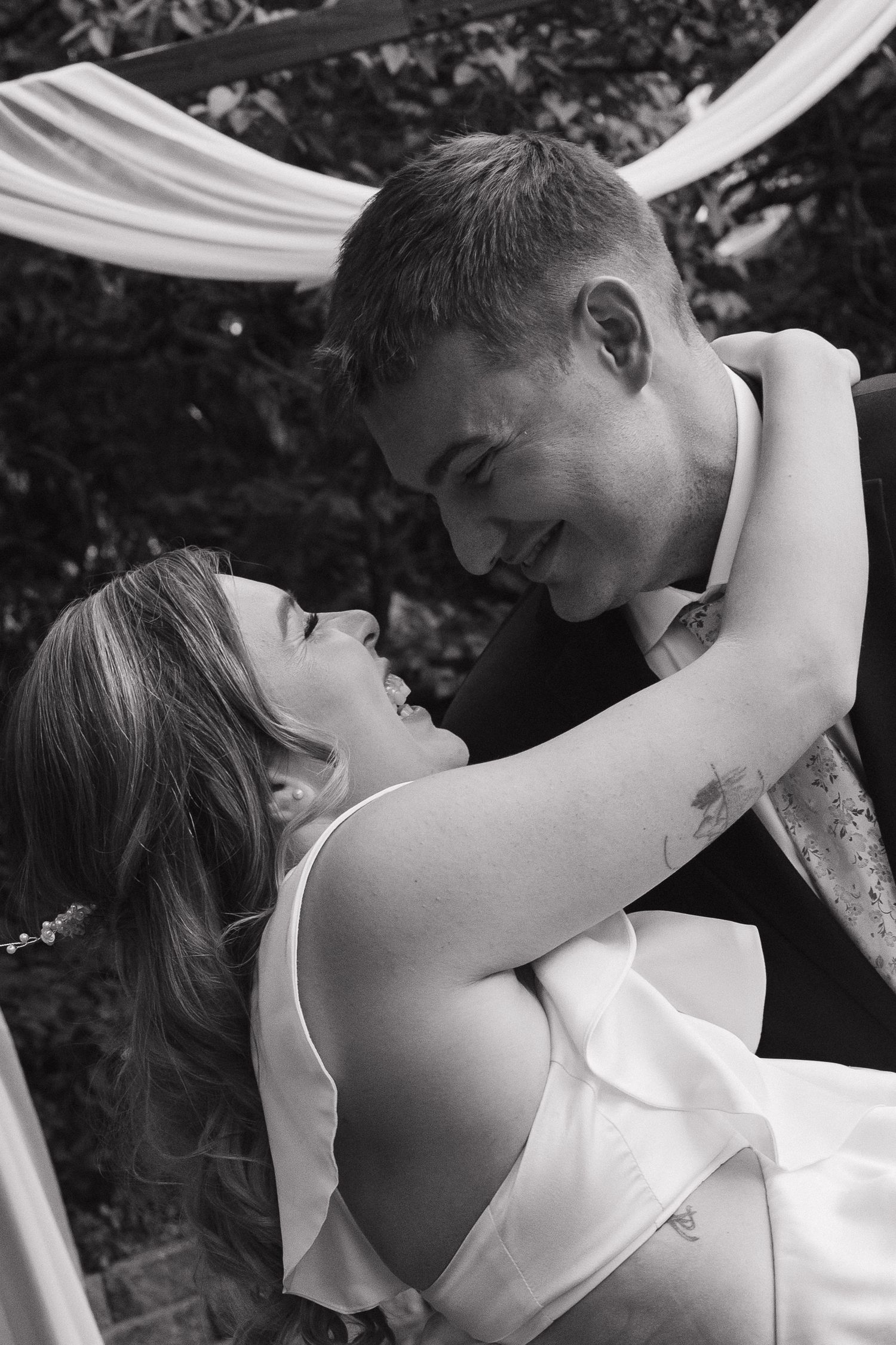 Bride sharing a joyful moment with husband during a wedding celebration