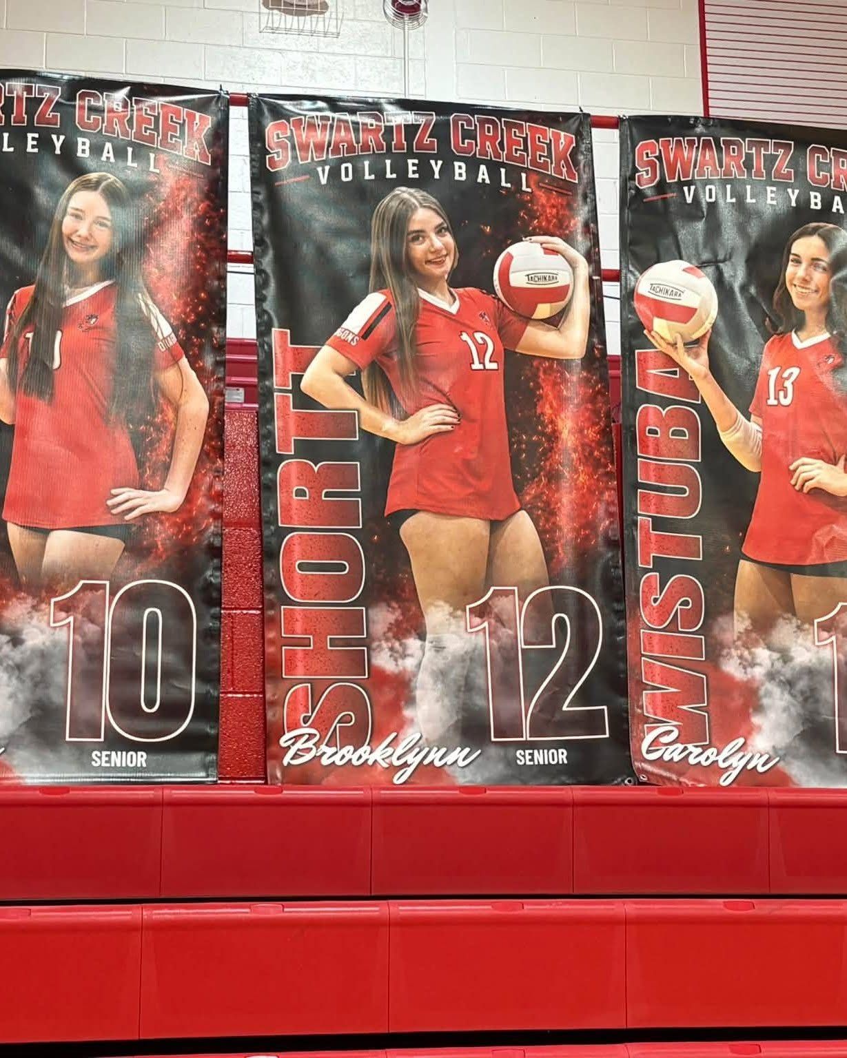 Custom Swartz Creek volleyball senior banners hanging in the gym