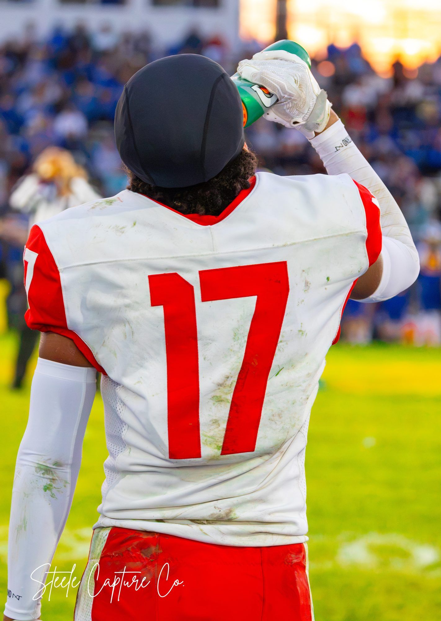 Swartz Creek Dragons football player #17 seen from behind at sunset, Swartz Creek MI sports photography