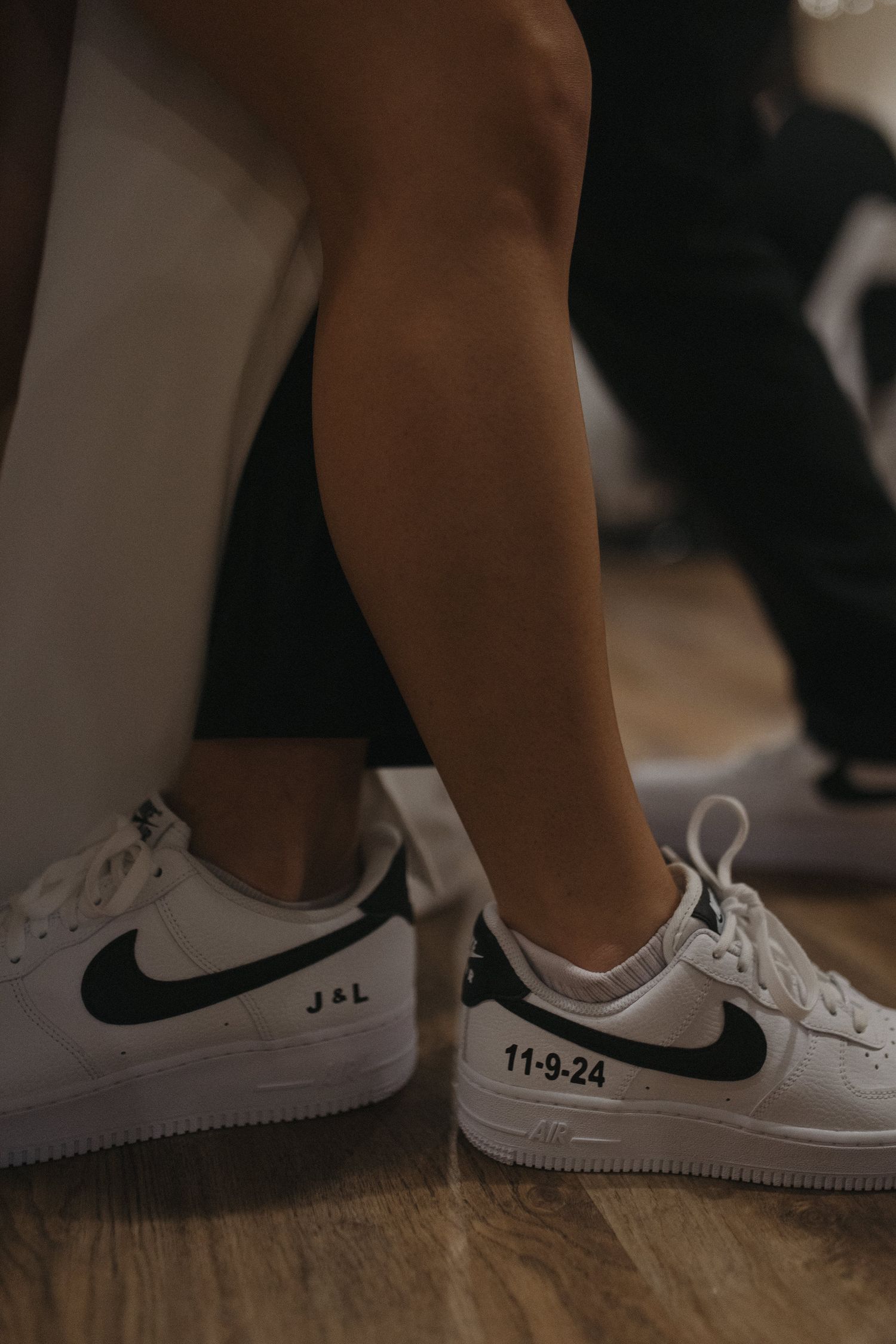 Custom Nike Air Force 1 sneakers with black swoosh, personalized with initials J&L and wedding date 11-9-24.