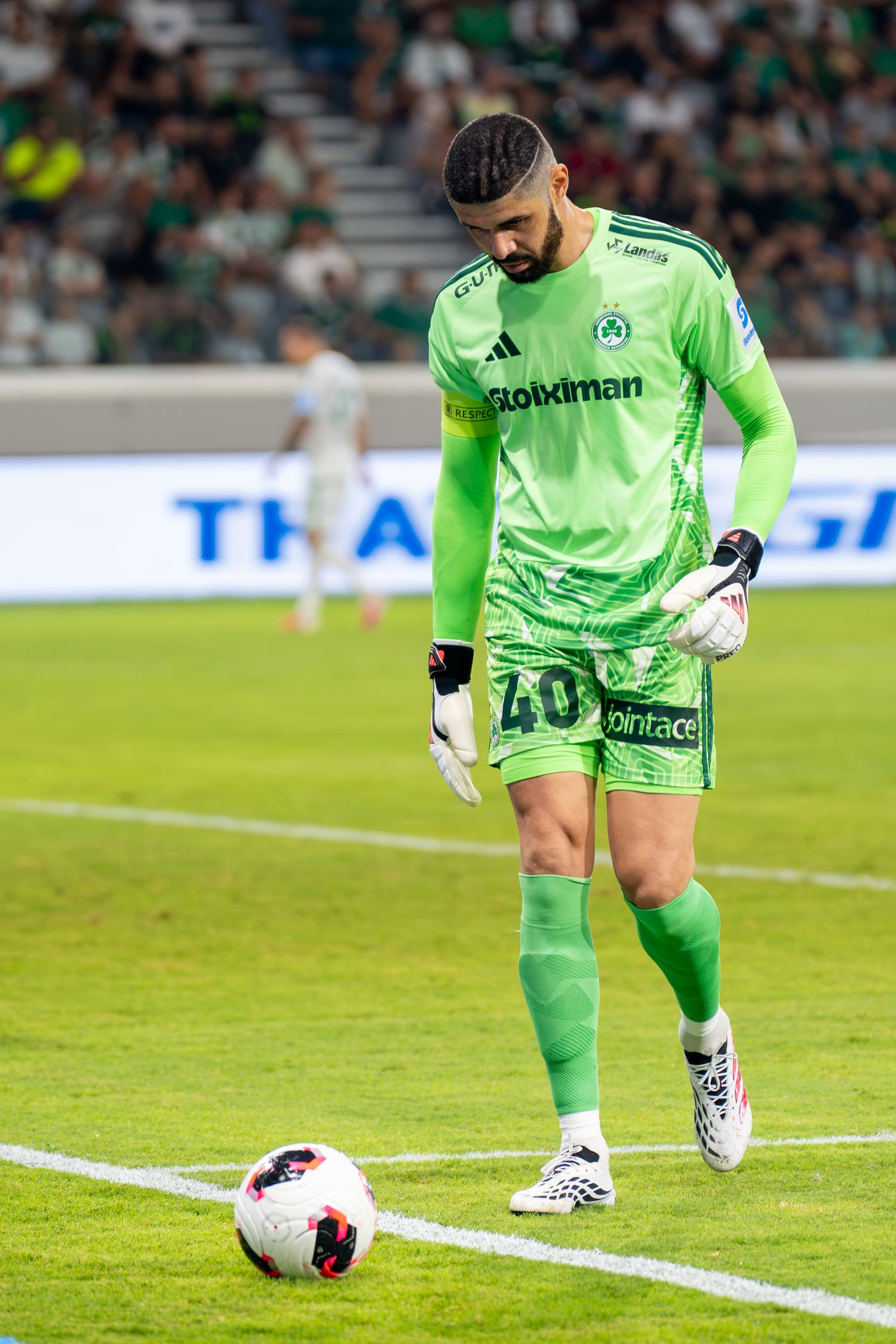 Goalkeeper number 40 in green Panathinaikos kit preparing to kick ball during football match.