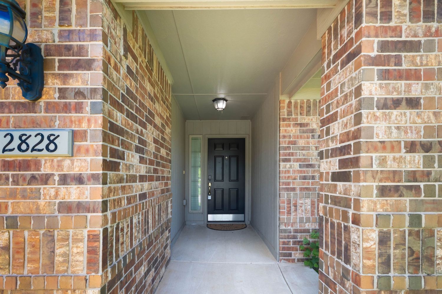 Covered Front Entry Hallway Real Estate Photography with Brick Detail in Oklahoma City