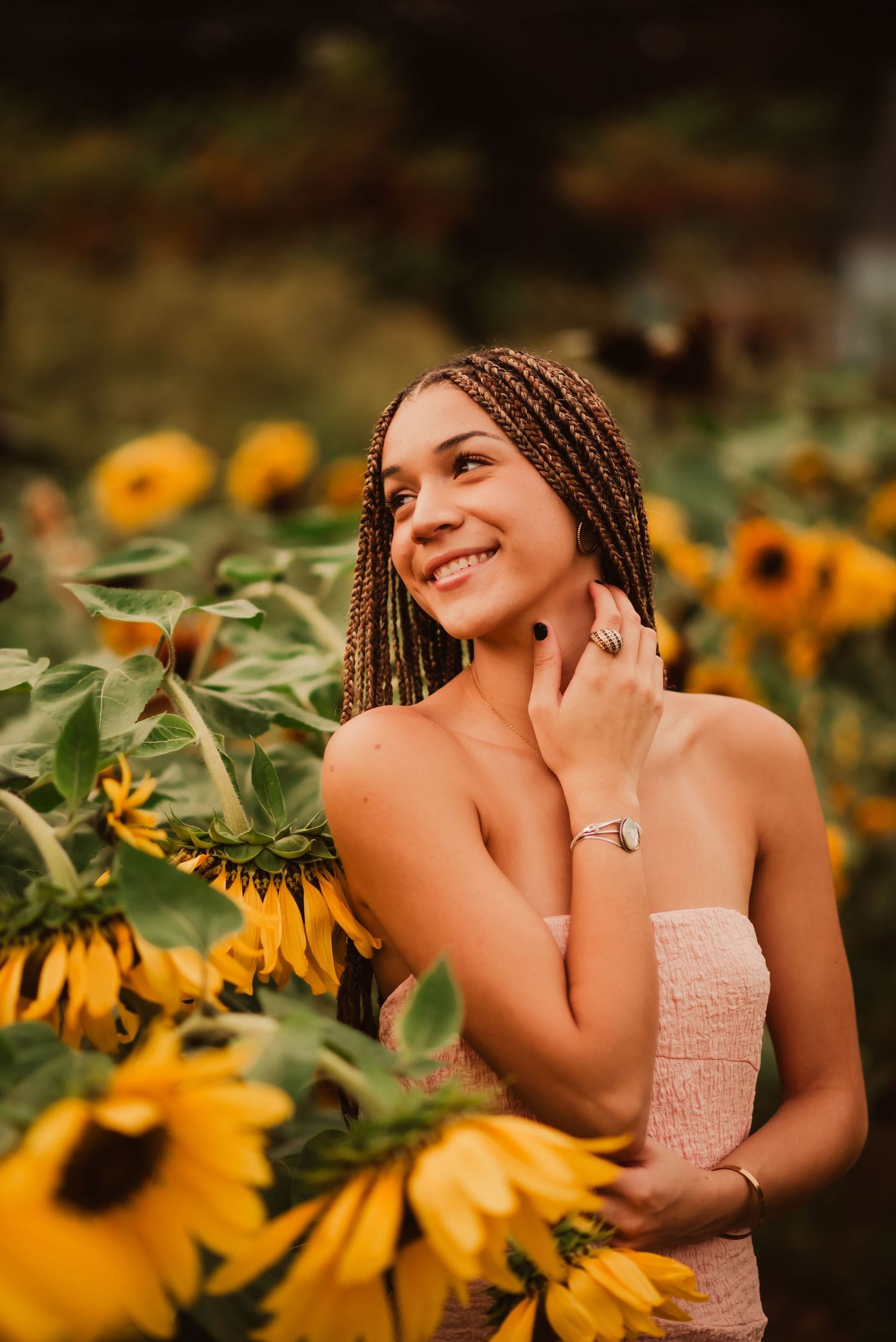 A series of artistic portraits taken in a vibrant sunflower field during golden hour with warm natural lighting.
