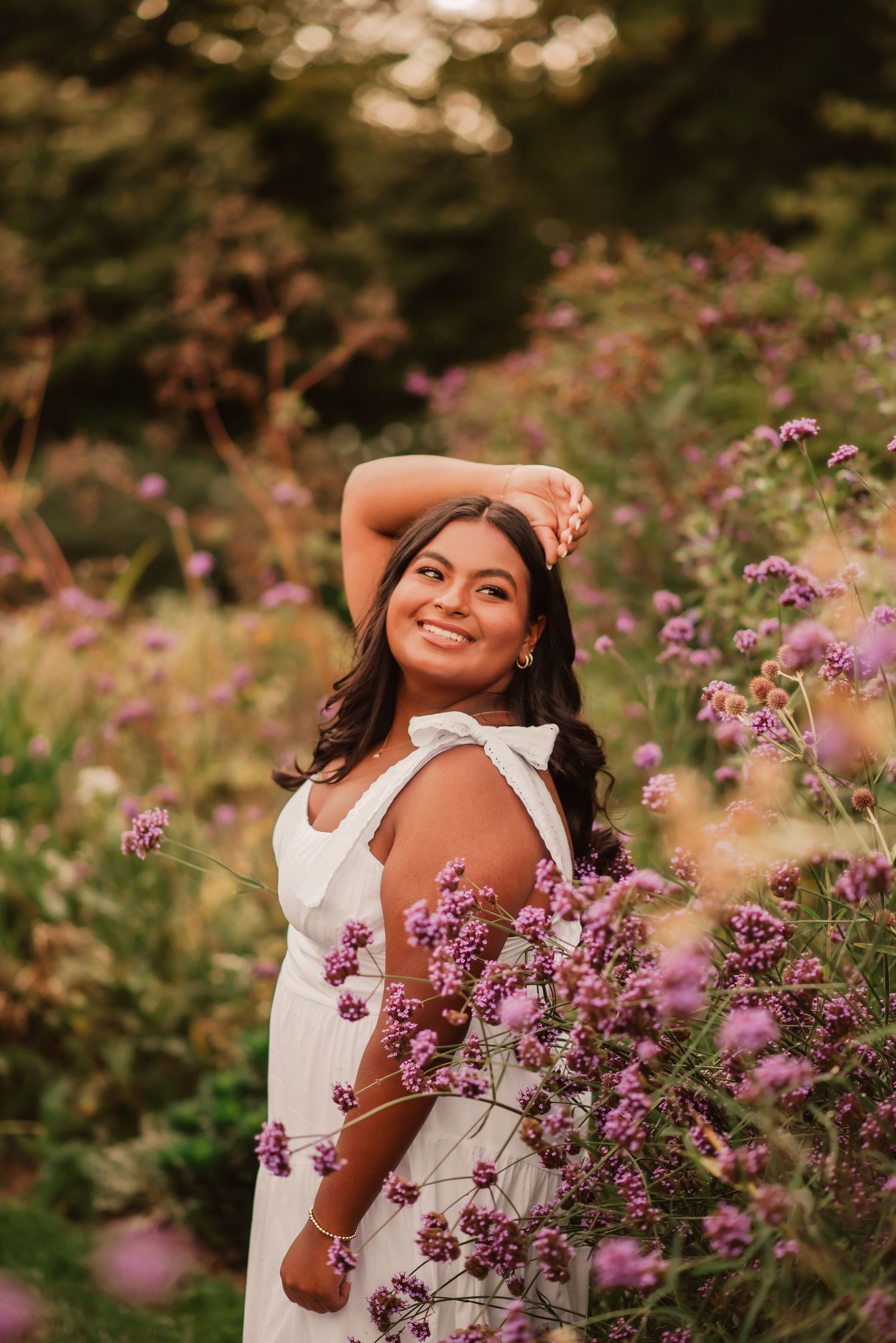 A joyful moment captured in a field of blooming purple wildflowers on a sunny autumn day.