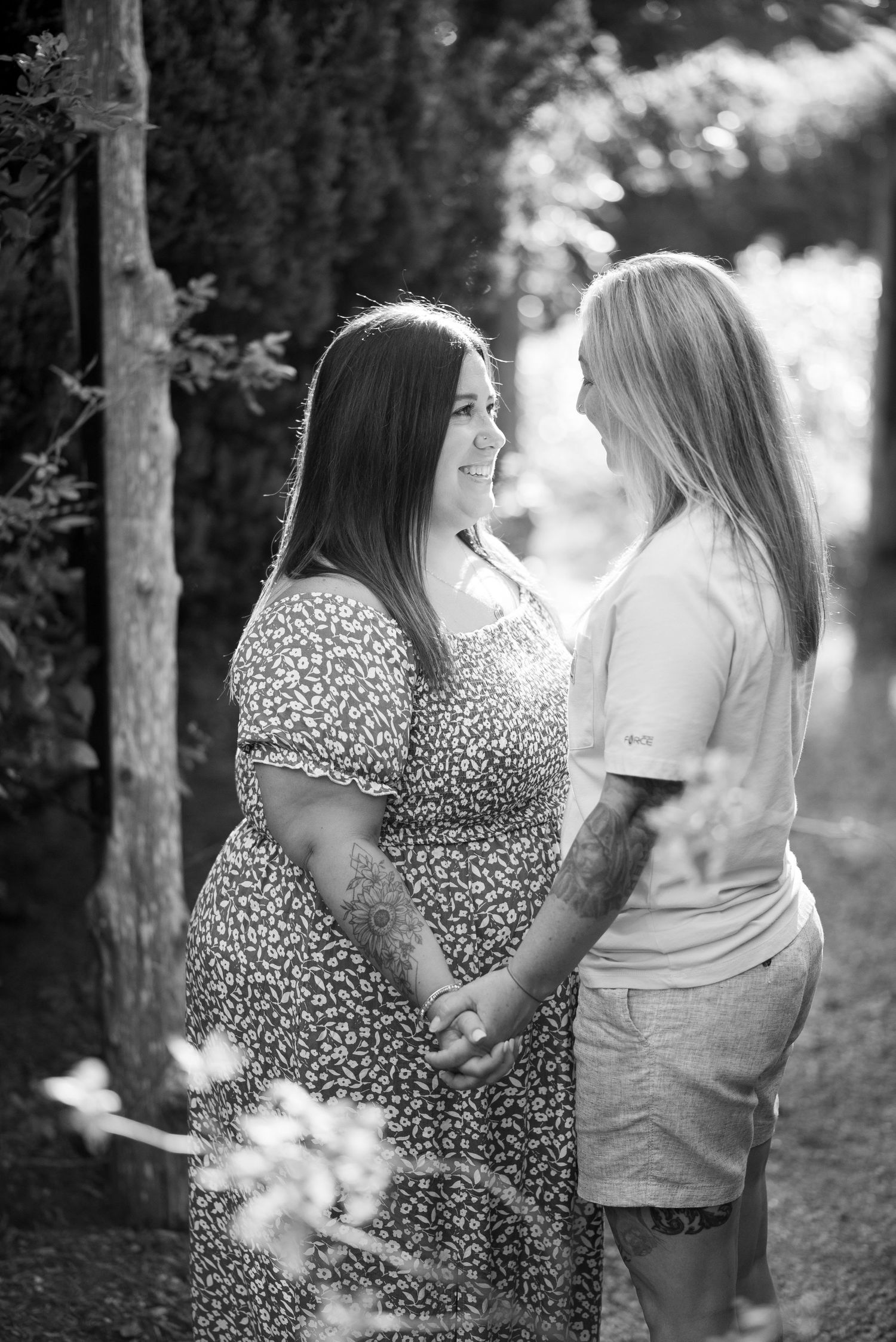 Black and white photo series showing two people in a forest setting, one wearing a leopard print dress and another in casual wear.