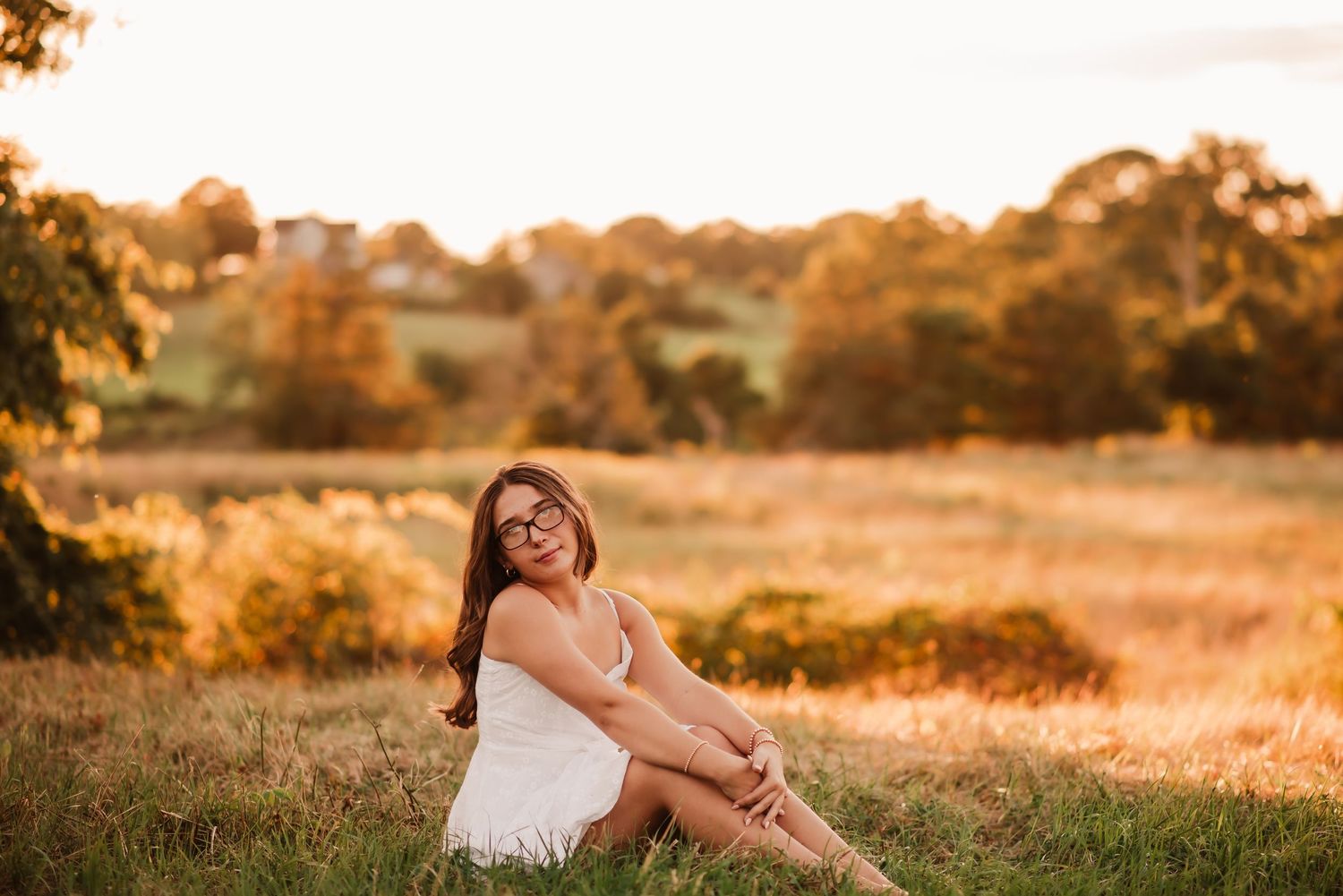 A series of sunset portraits captured in a golden field during magic hour with warm autumn tones.