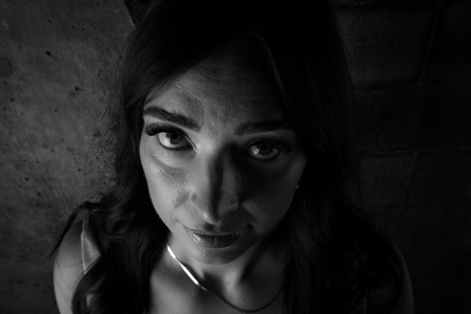 Dramatic black and white portrait with moody lighting.