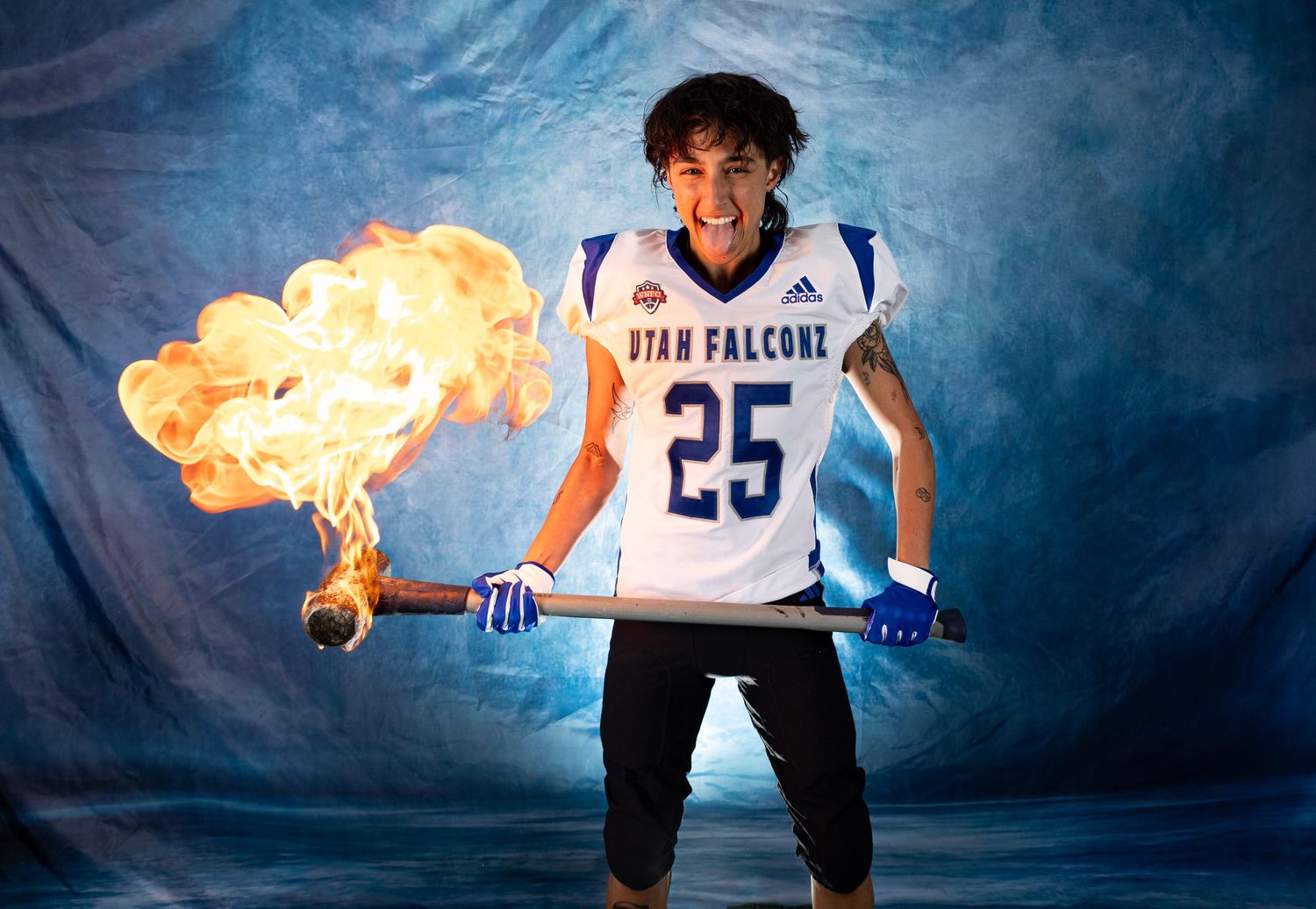 Basketball player in blue and white uniform performs dynamic action poses with fire effects against dark background.