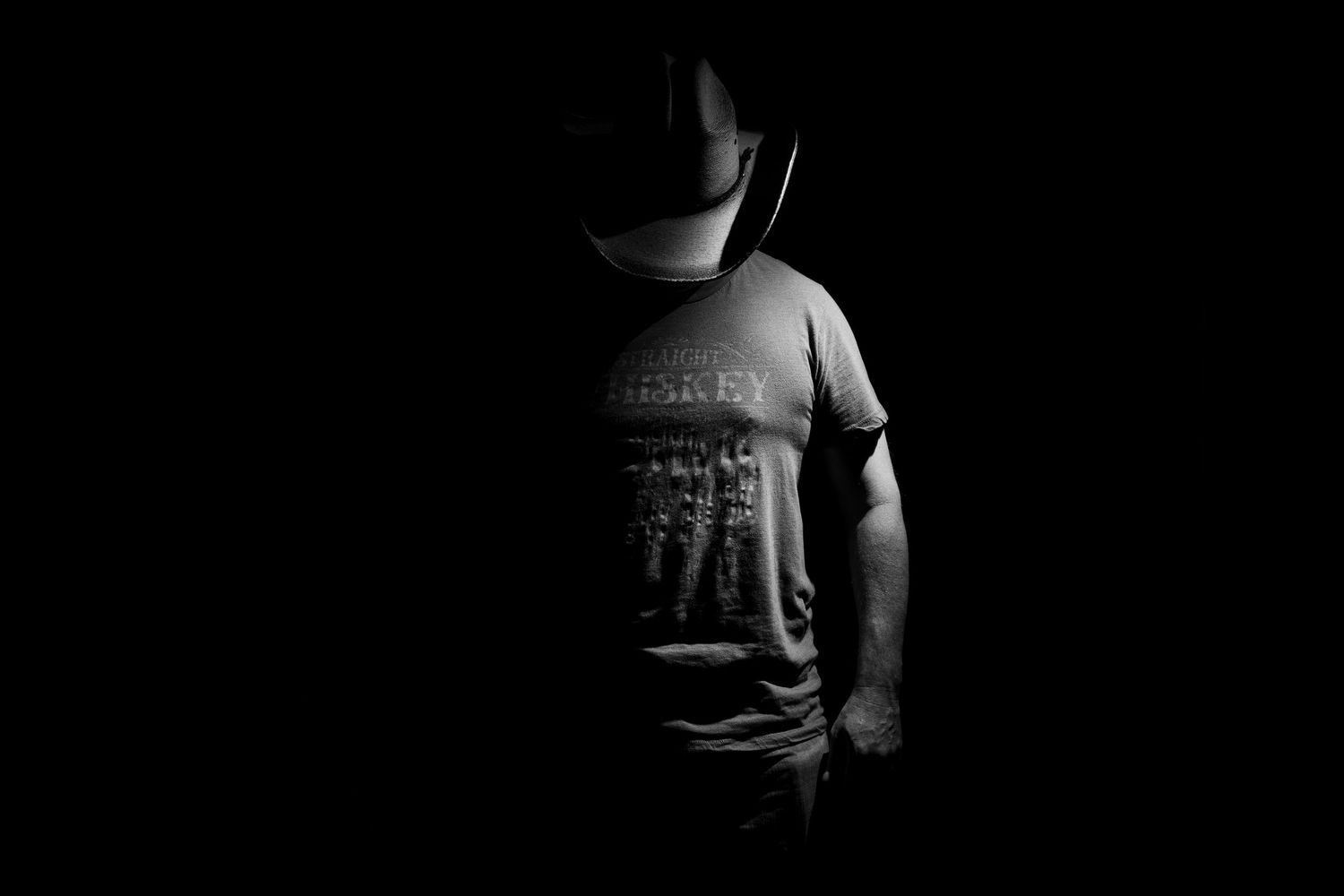 Dramatic black and white portrait series with strong contrast and shadows.