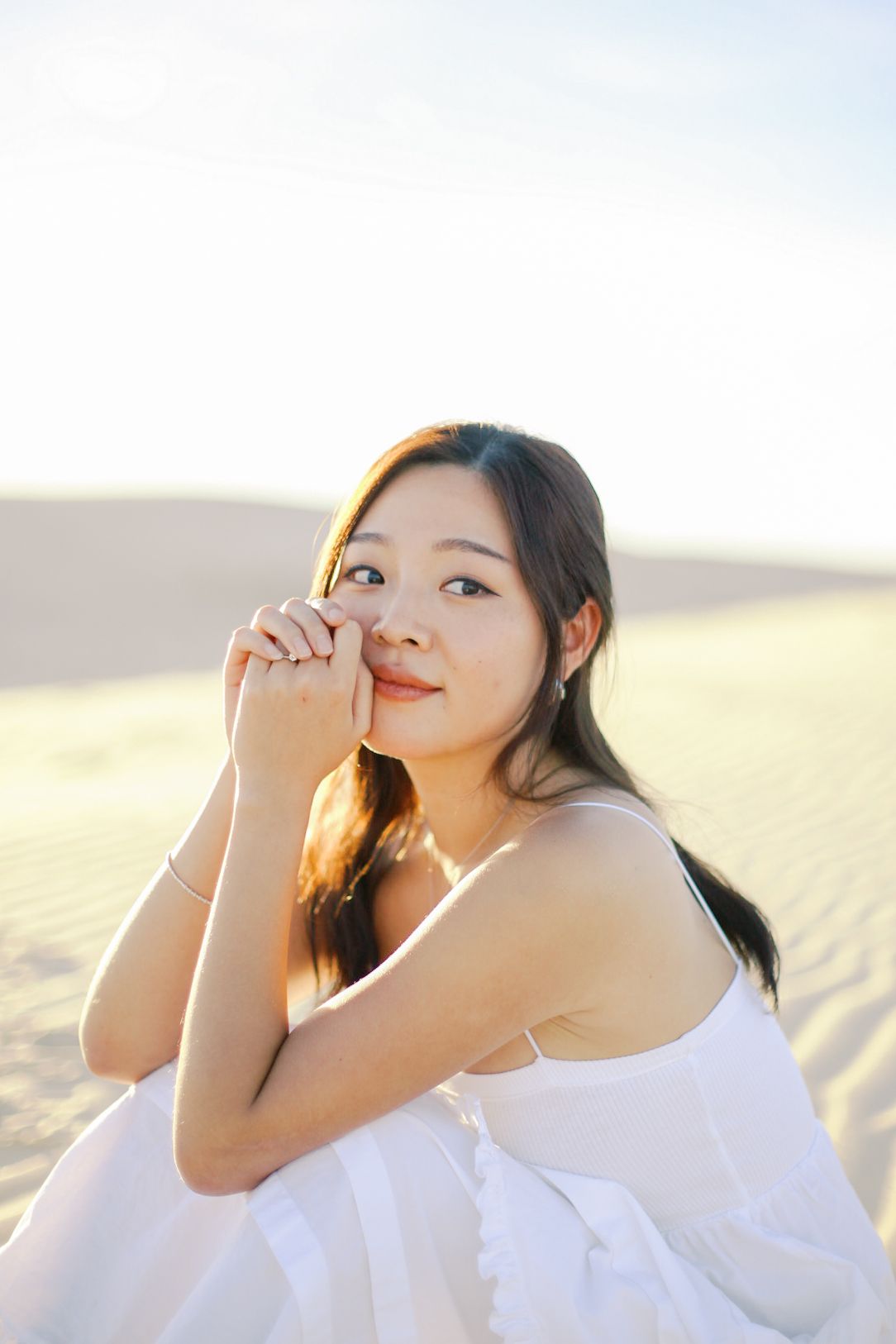Senior portraits in open field with soft light, timeless and natural senior photography DFW beach, sand, dune senior session