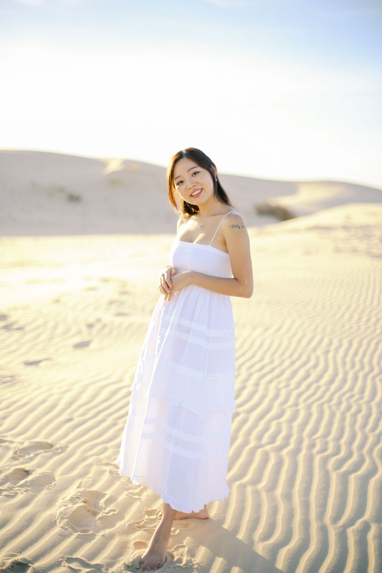 Senior portraits in open field with soft light, timeless and natural senior photography DFW beach, sand, dune senior session