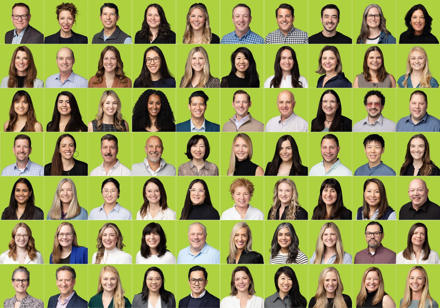 A group of smiling professionals from Nature's Path Organic posed for individual headshots taken at their Vancouver customer conference.
