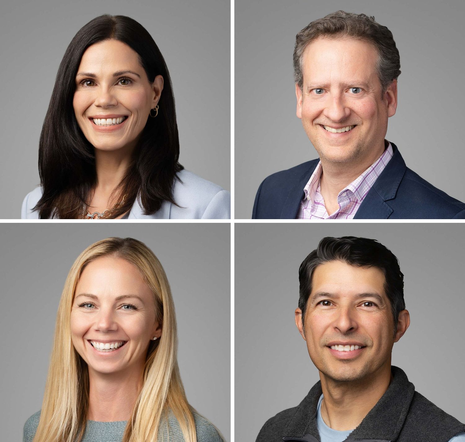 Four professional headshots of smiling business professionals, two women and two men, posed against a gray background.