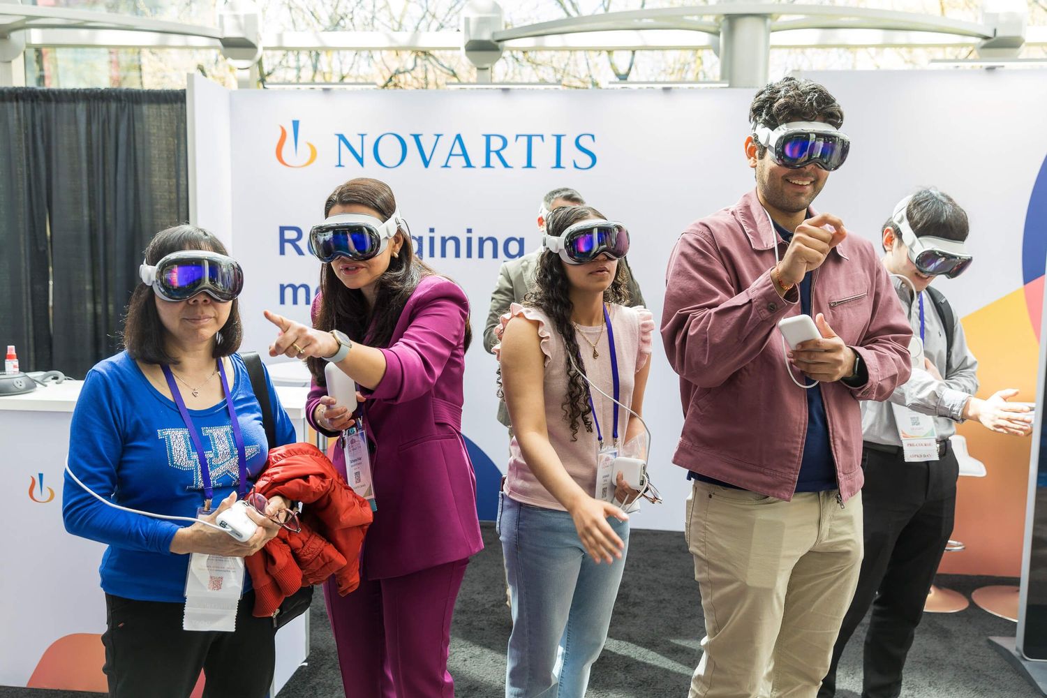 Attendees try Novartis VR headsets at an interactive booth during a medical conference held at the Sneraton Wall Centre Vancouver.