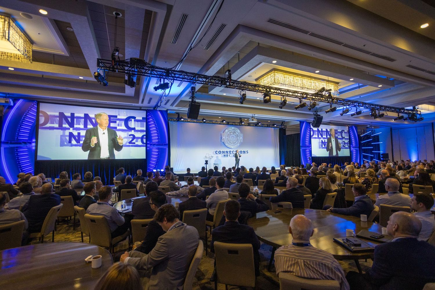 Large audience attending the Connections NBC 2025 conference in a grand ballroom organized by Raymond James at JW Marriott Parq Vancouver.