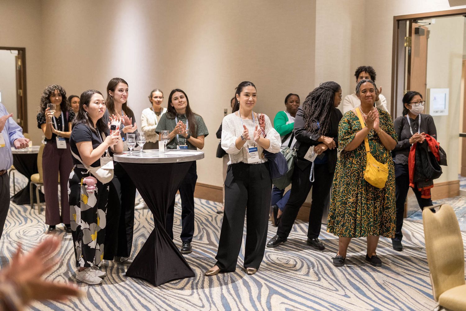 Diverse group of professional women networking and socializing at a conference event at the Vancouver Marriott Pinnacle Hotel.