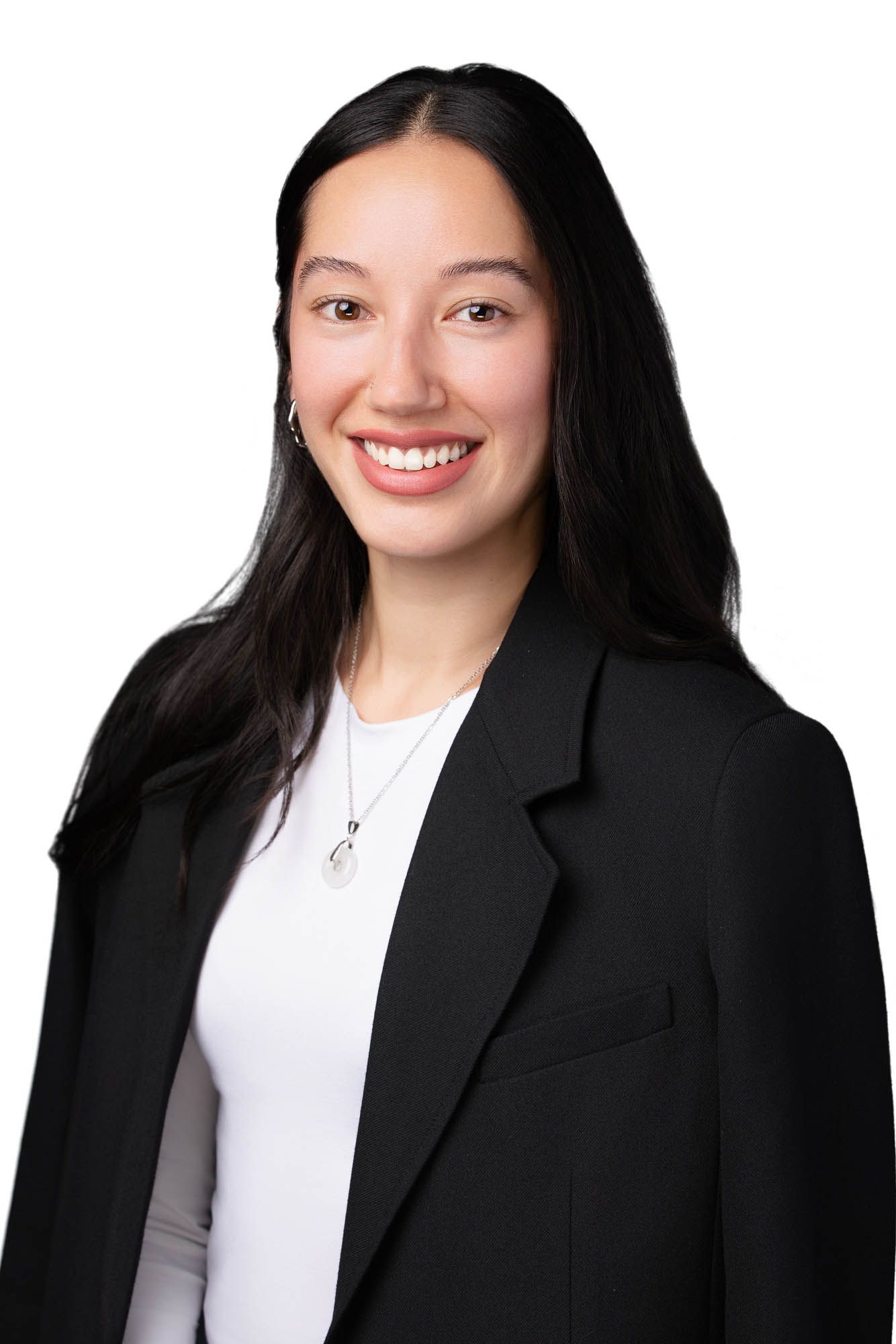 Professional headshot of a smiling young woman with long dark hair wearing a black blazer and white top.