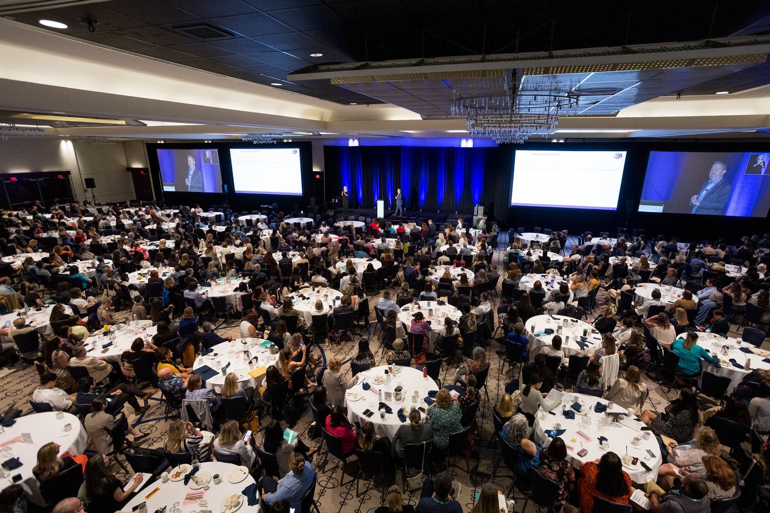 Large conference banquet hall at Hyatt Regency Vancouver filled with guests seated at round tables.