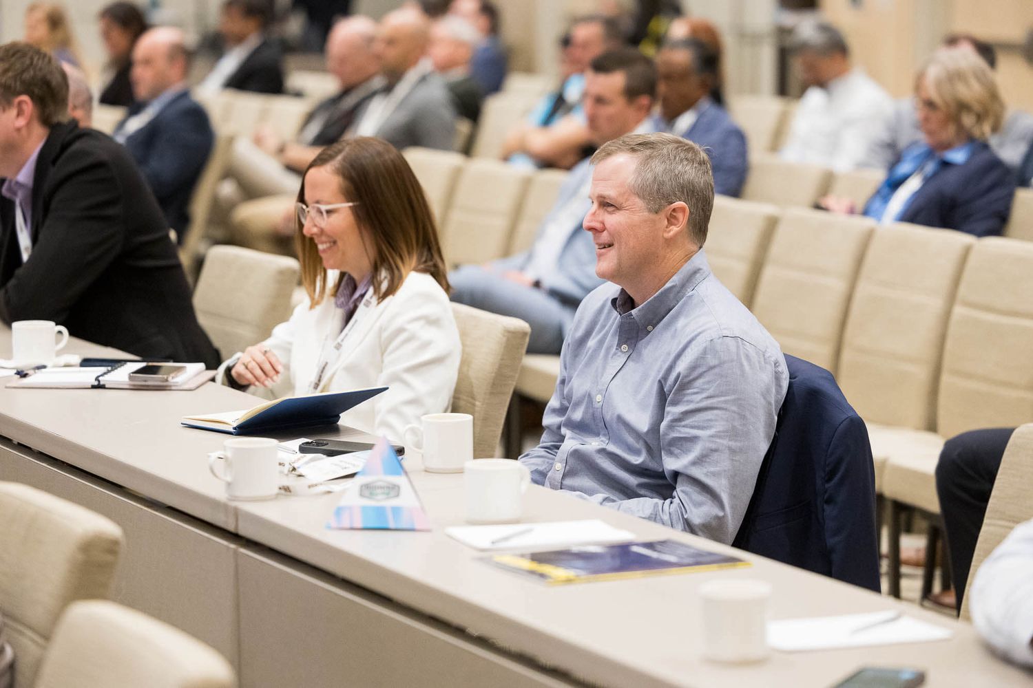 Professionals smile and engage during a corporate conference room meeting at the JW Marriott Parq Vancouver.