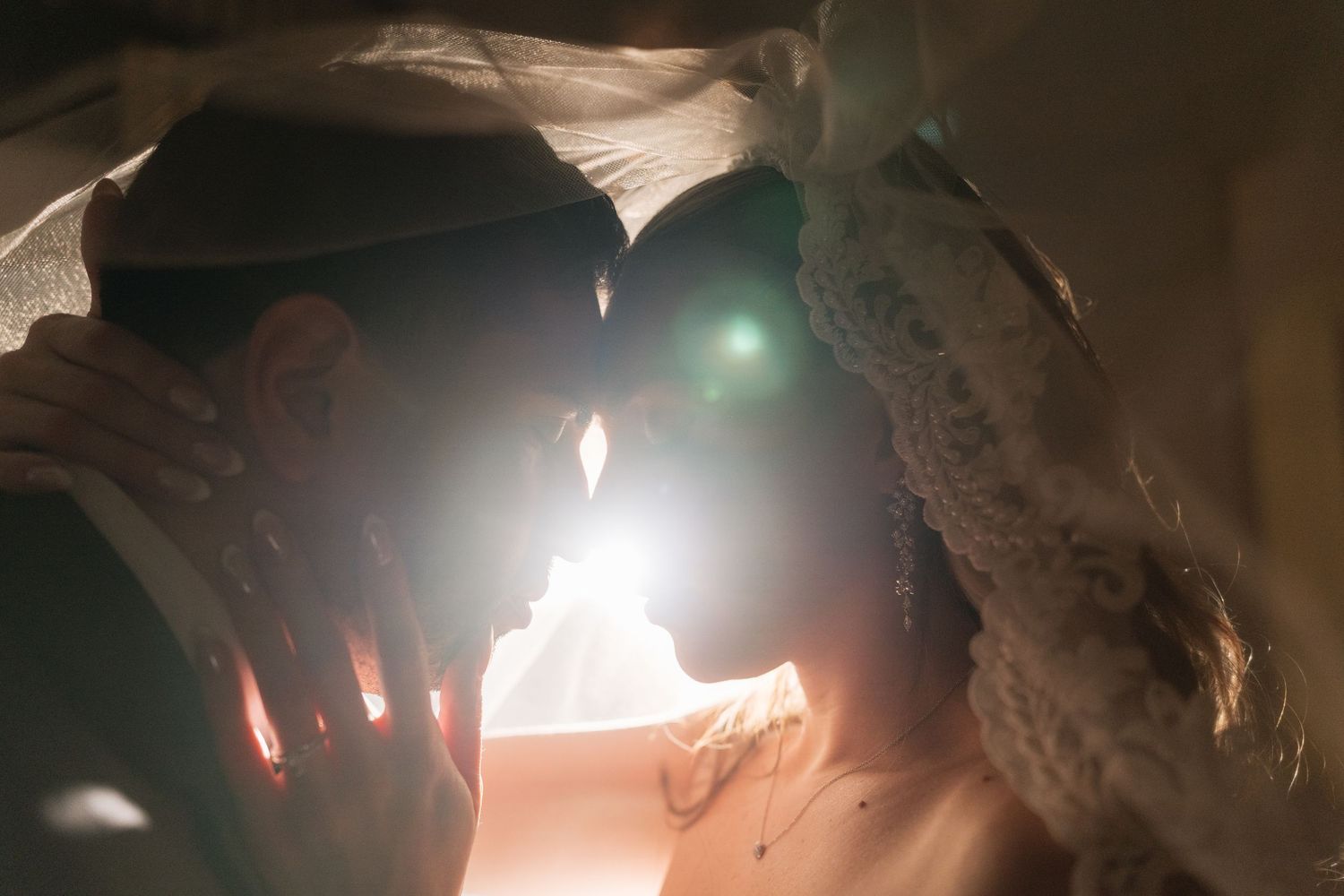 Soft focus wedding photography with dramatic backlighting creates an ethereal atmosphere.