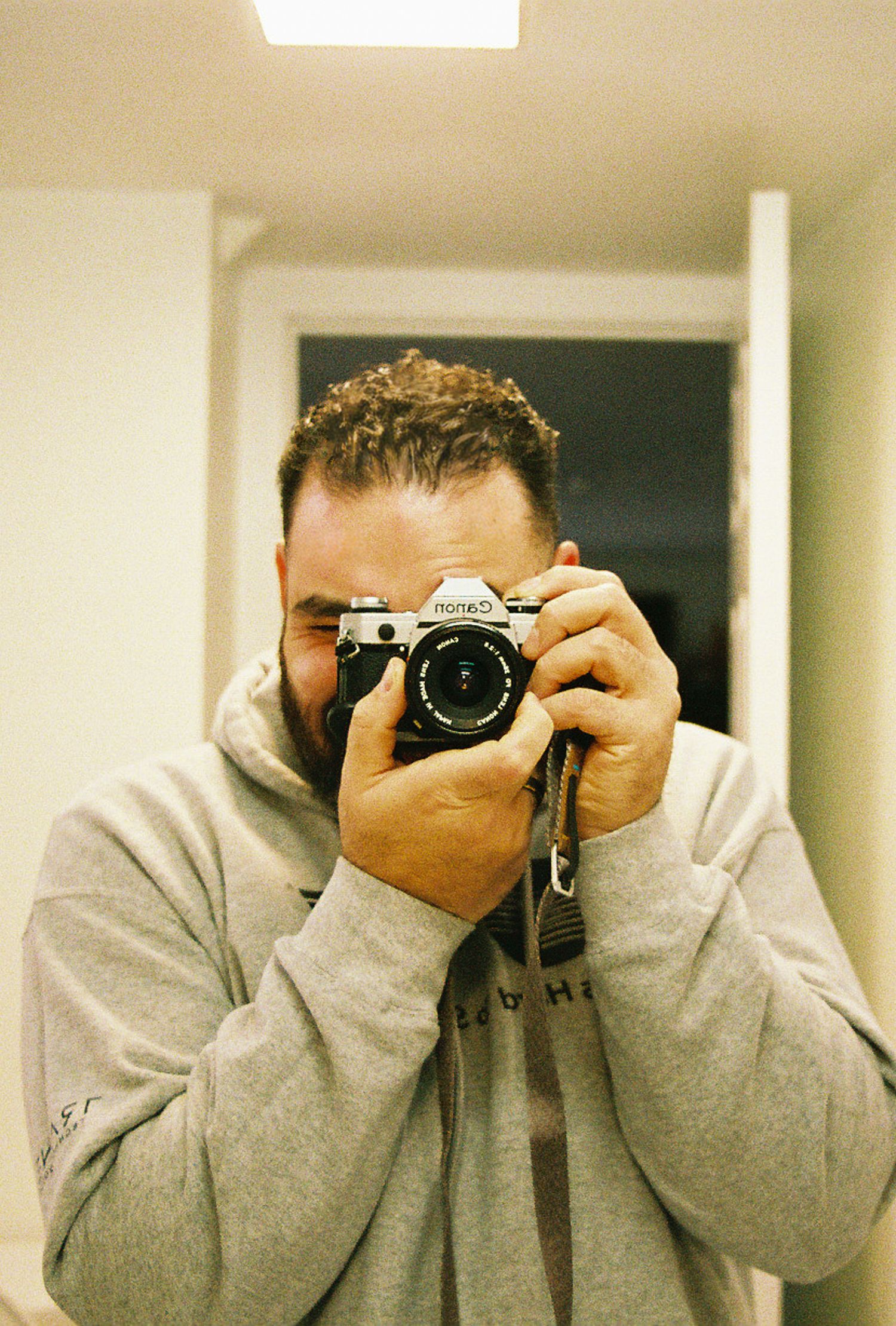 Series of selfie photos showing someone taking pictures with a vintage film camera.