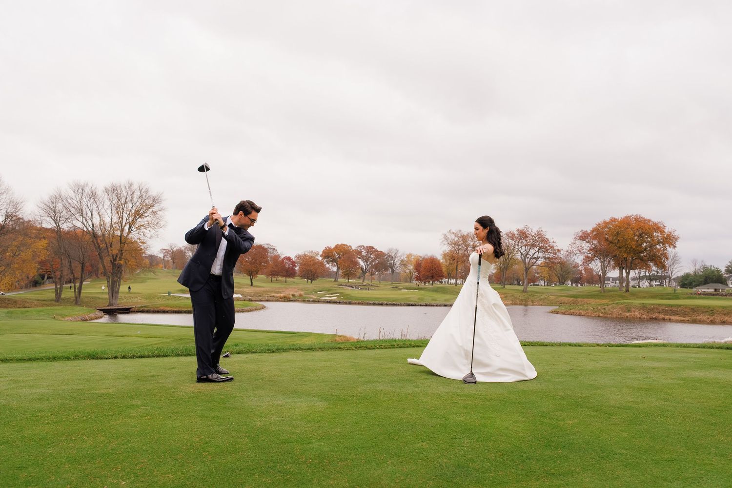 Wedding photography session on a sprawling golf course with dramatic dress shots.